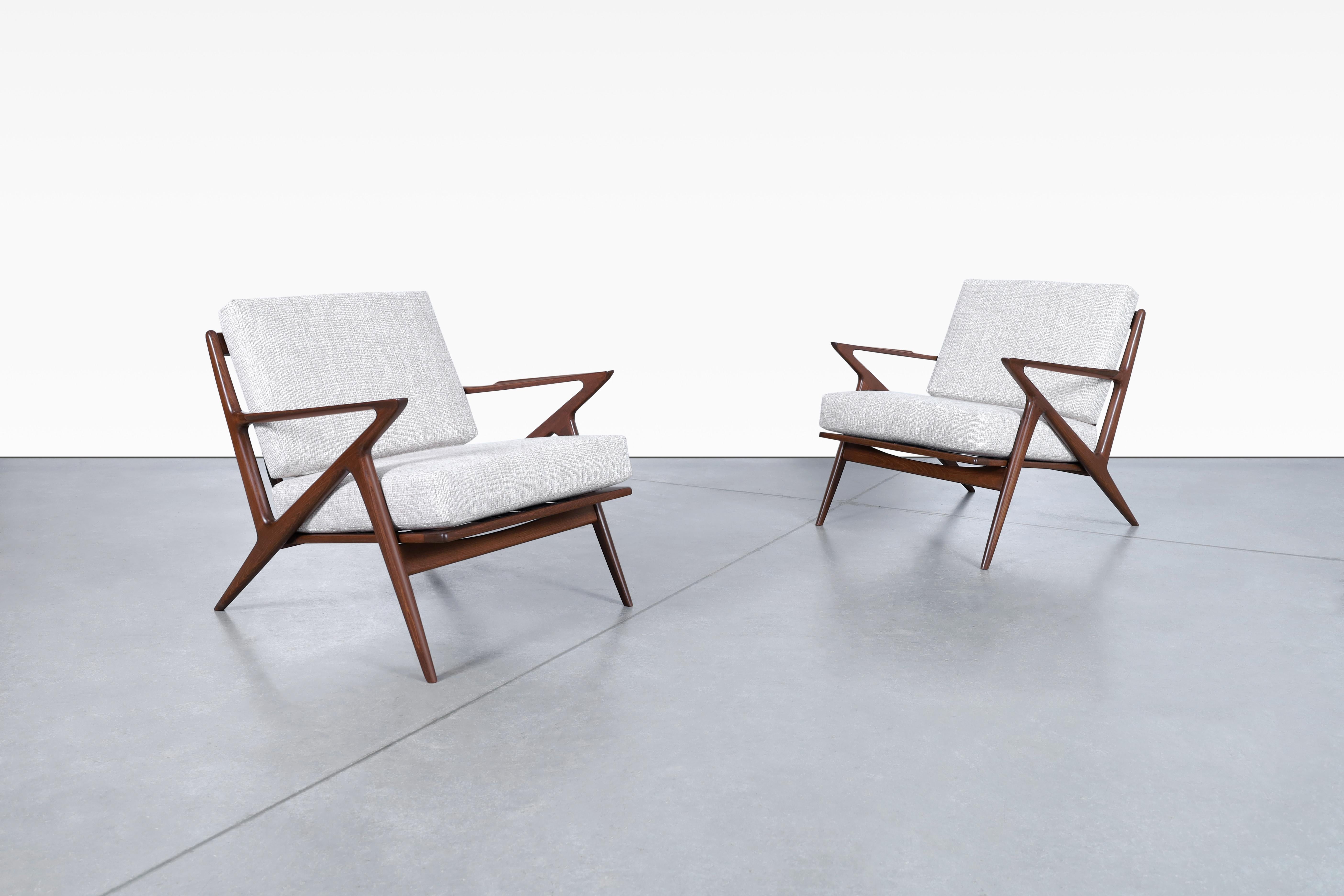 Beautiful Danish modern walnut lounge chairs designed by Poul Jensen for Selig, in Denmark, circa 1960’s. Known as the “Z” chair for its exclusive armrests that connect to the legs and give the illusion of a letter Z. These chairs stand out for the