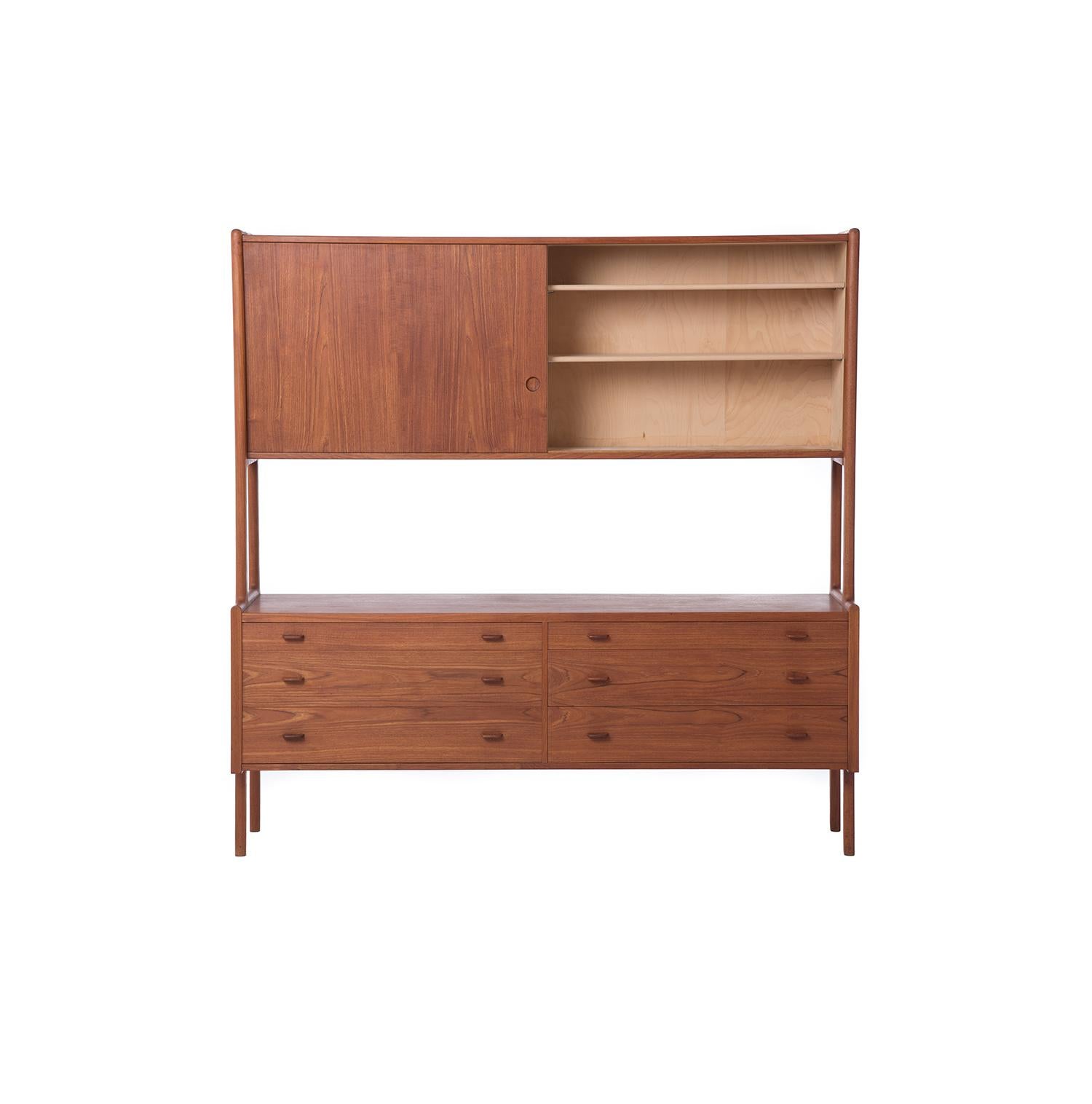 This two-tiered teak Hans Wegner sideboard features six drawers on the lower half and adjustable shelving behind two large sliding doors on the upper component.