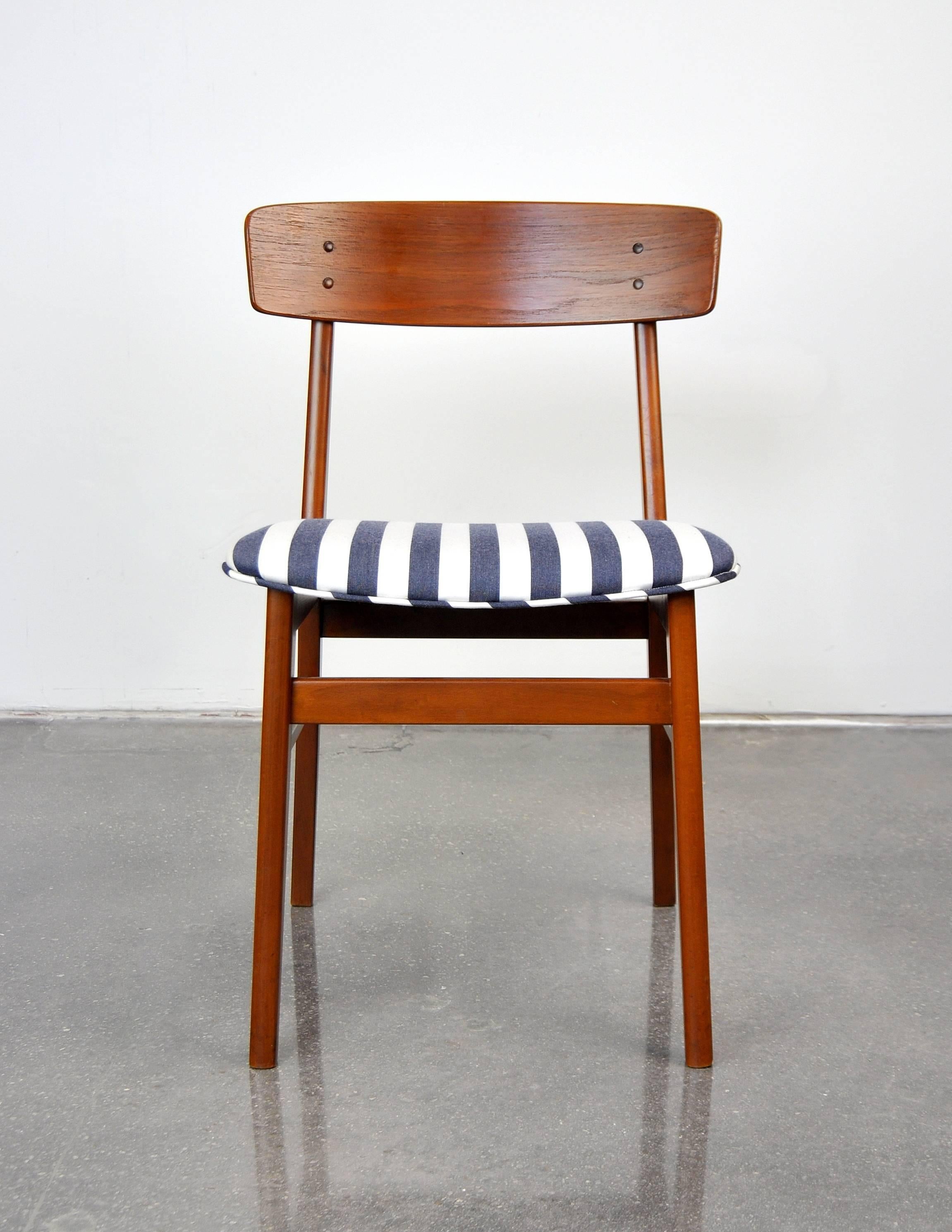 A 1960s Mid-Century Modern vintage side chair; can be used as a desk, dining or accent chair. The seat was recently recovered in a nautical style blue and white striped fabric. The solid teak frame shows rich, deep patina. Please contact Select