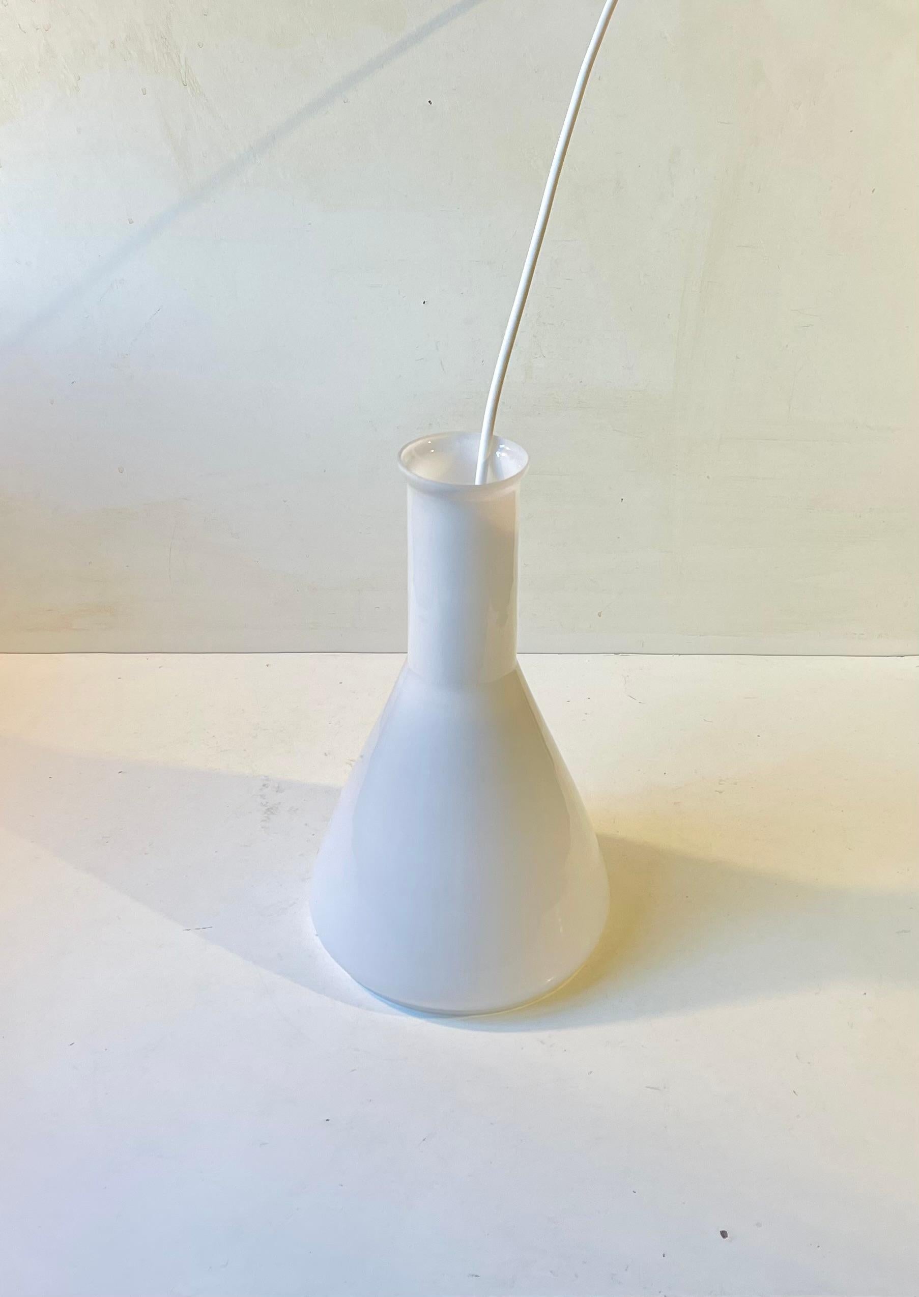 Organically shaped pendant lamp in white opaline glass. Possibly made by Holmegaard in Denmark during the 1960s based upon a design by Jacob E. Bang. Measurements: H: 30 cm, Diameter: 18 cm. It comes installed with 3 meters new white cord.