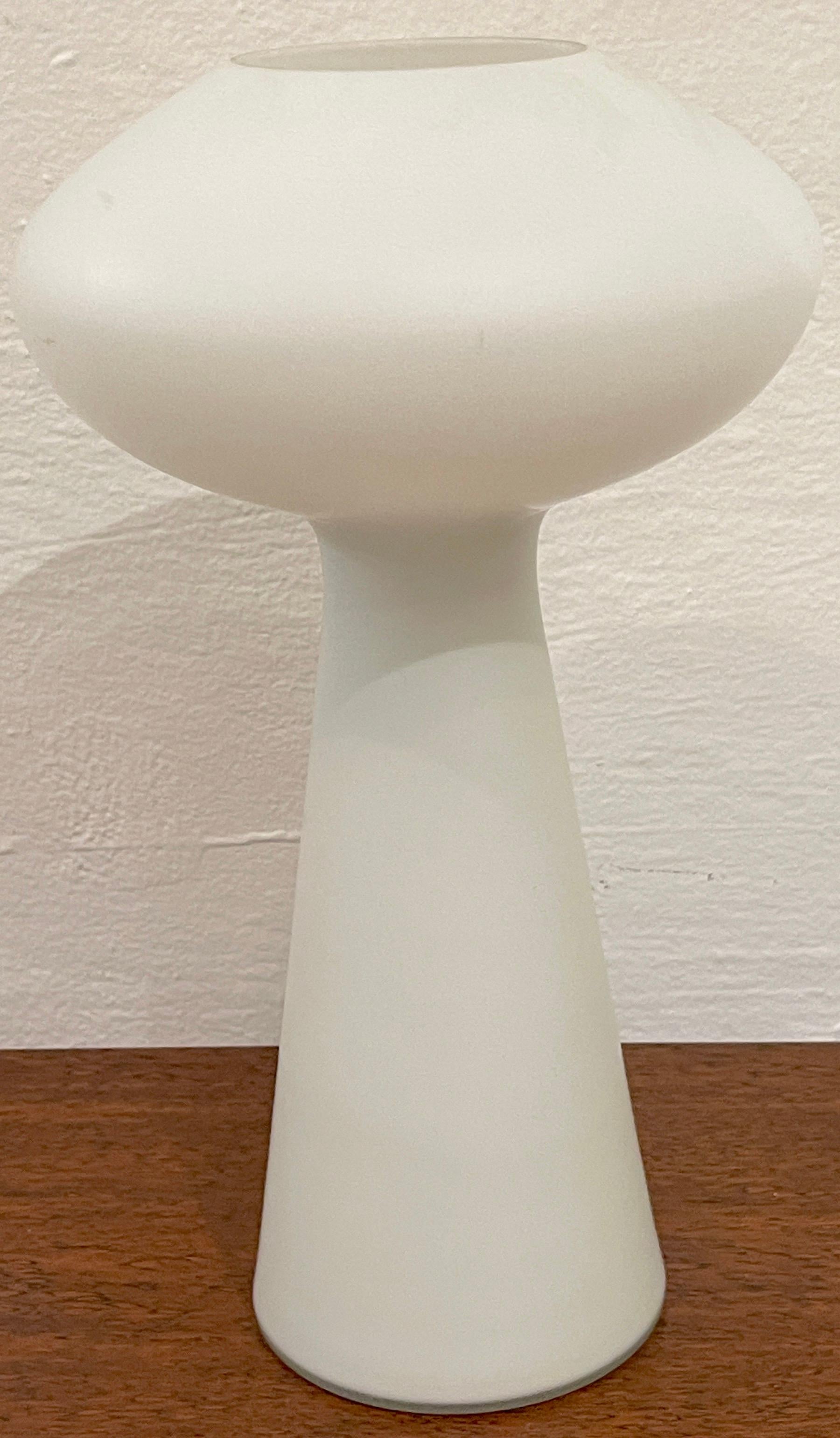 Danish modern white opaque glass mushroom lamp by Lisa Johansson-Pape 
Denmark, Circa 1960s

Of typical form, a fine example of Danish modern design, The mushroom top, fitted for a single standard US bulb up to 60w, raised on a tapering column.