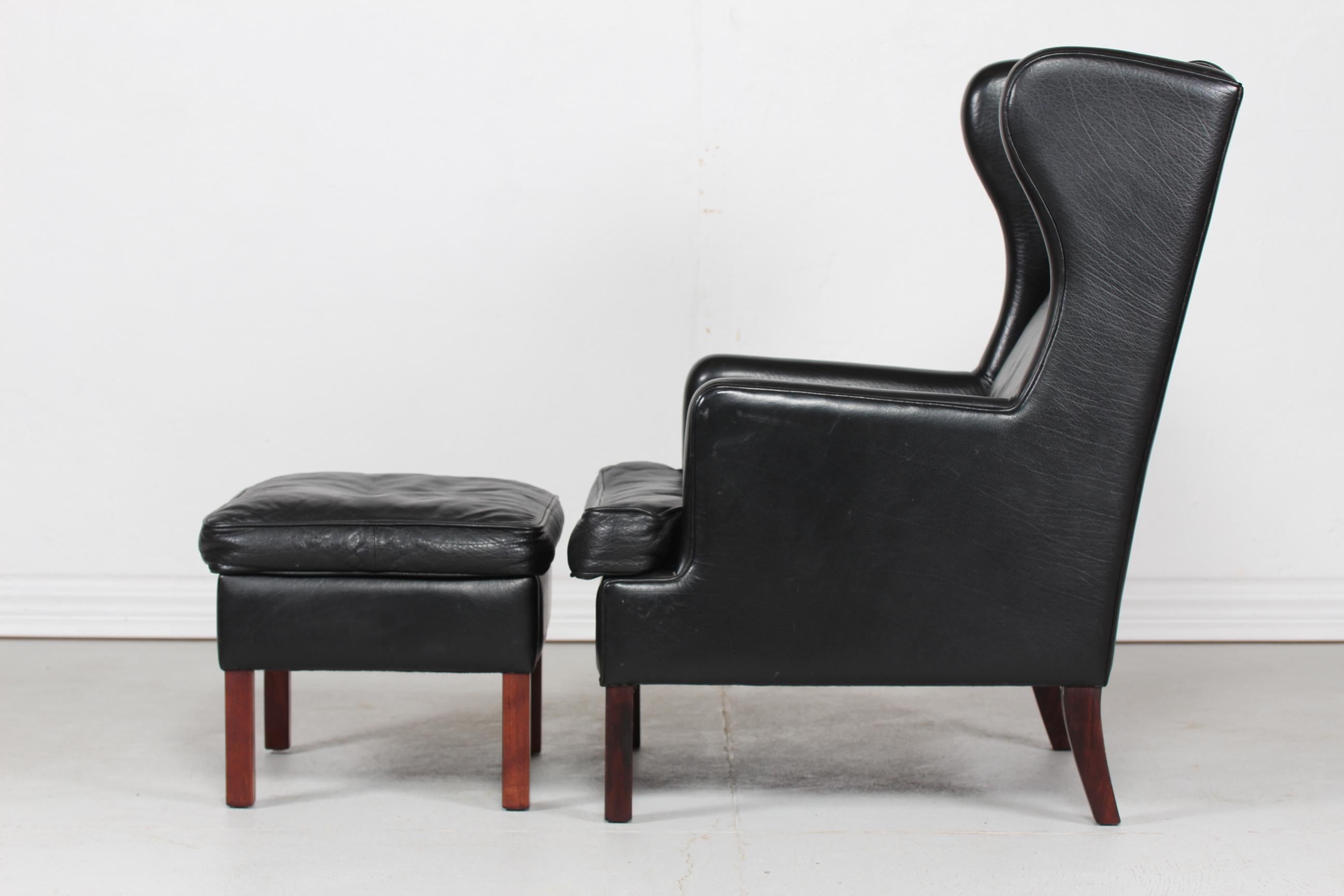 Late 20th Century Danish Modern Wingback Chair and Stool with Black Leather in Kaare Klint Style For Sale