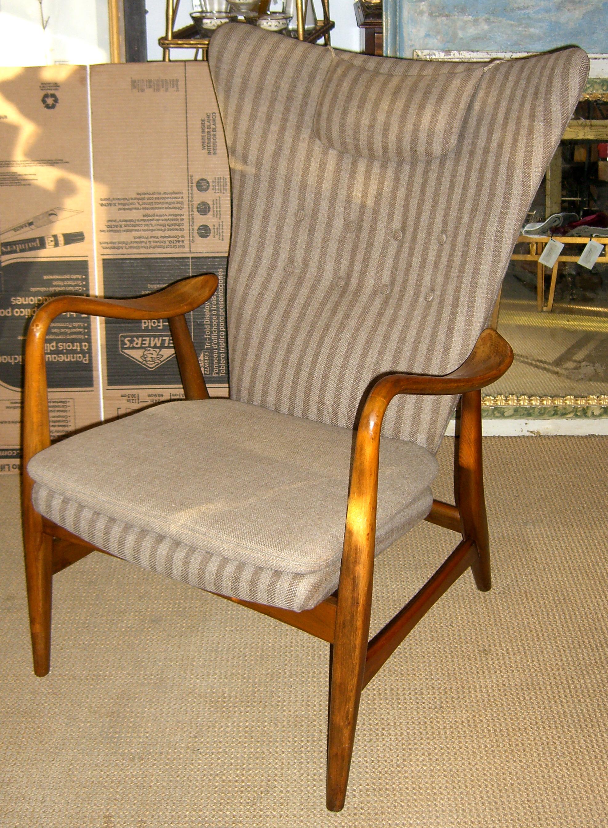 A stunning example of Danish modern design. Produced by Bovenkamp this wing back chair has unique free floating curved arms. The upholstery is original.