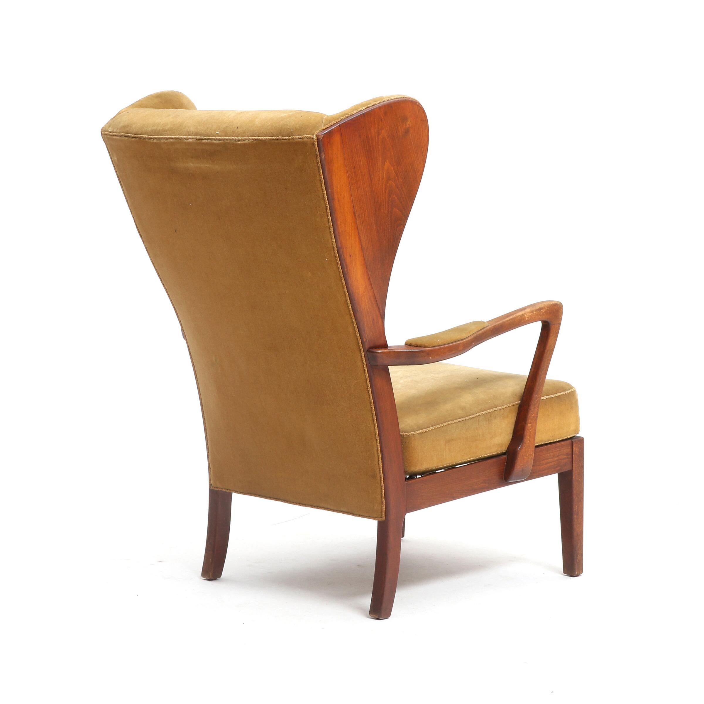 Danish cabinet maker, JUM-Stolen, wing-backed armchair with stained beech frame, seat and back upholstered with light wool, 1940s.