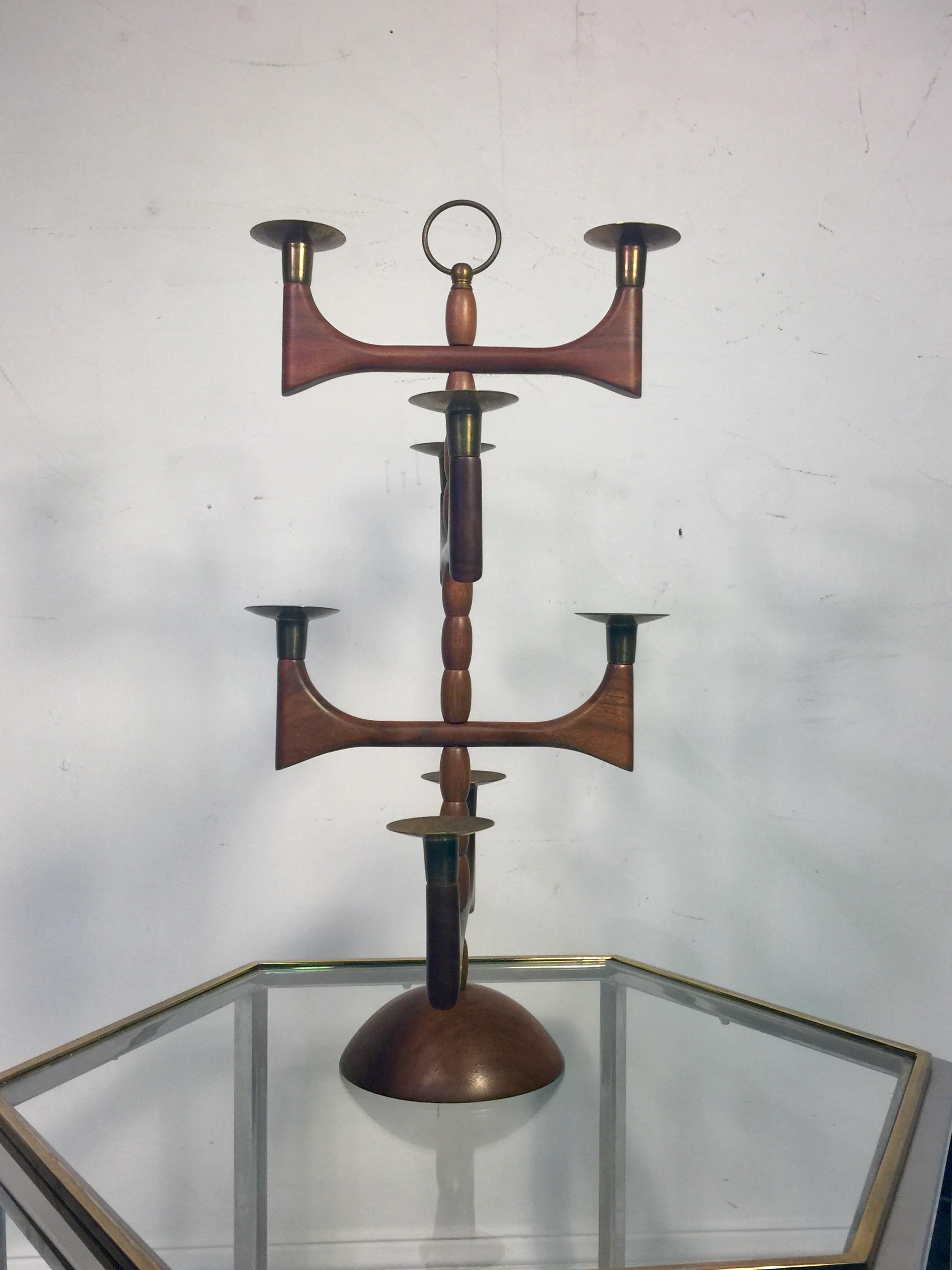 Midcentury Danish wood and brass candelabra with eight candleholders and brass ring finial that you can use for carrying the candelabra. Great design for a Mid-Century Modern dining table. The diameter of the base is 6 1/4