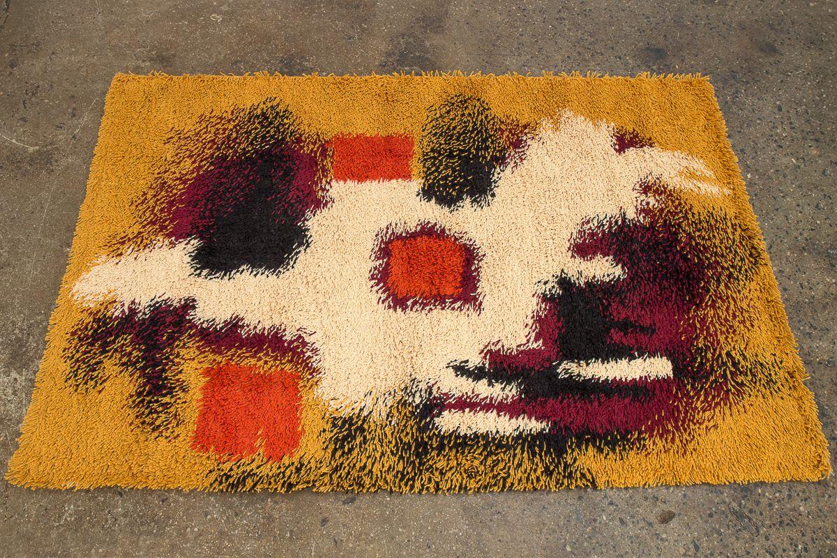 Danish modern Rya wool area rug produced by Ege. Plush and cozy, with deep ochre yellow, navy blue, maroon and cream in an abstract pattern. Rug is brand new old stock from the 1960s - has never been used. Made in Denmark.
 