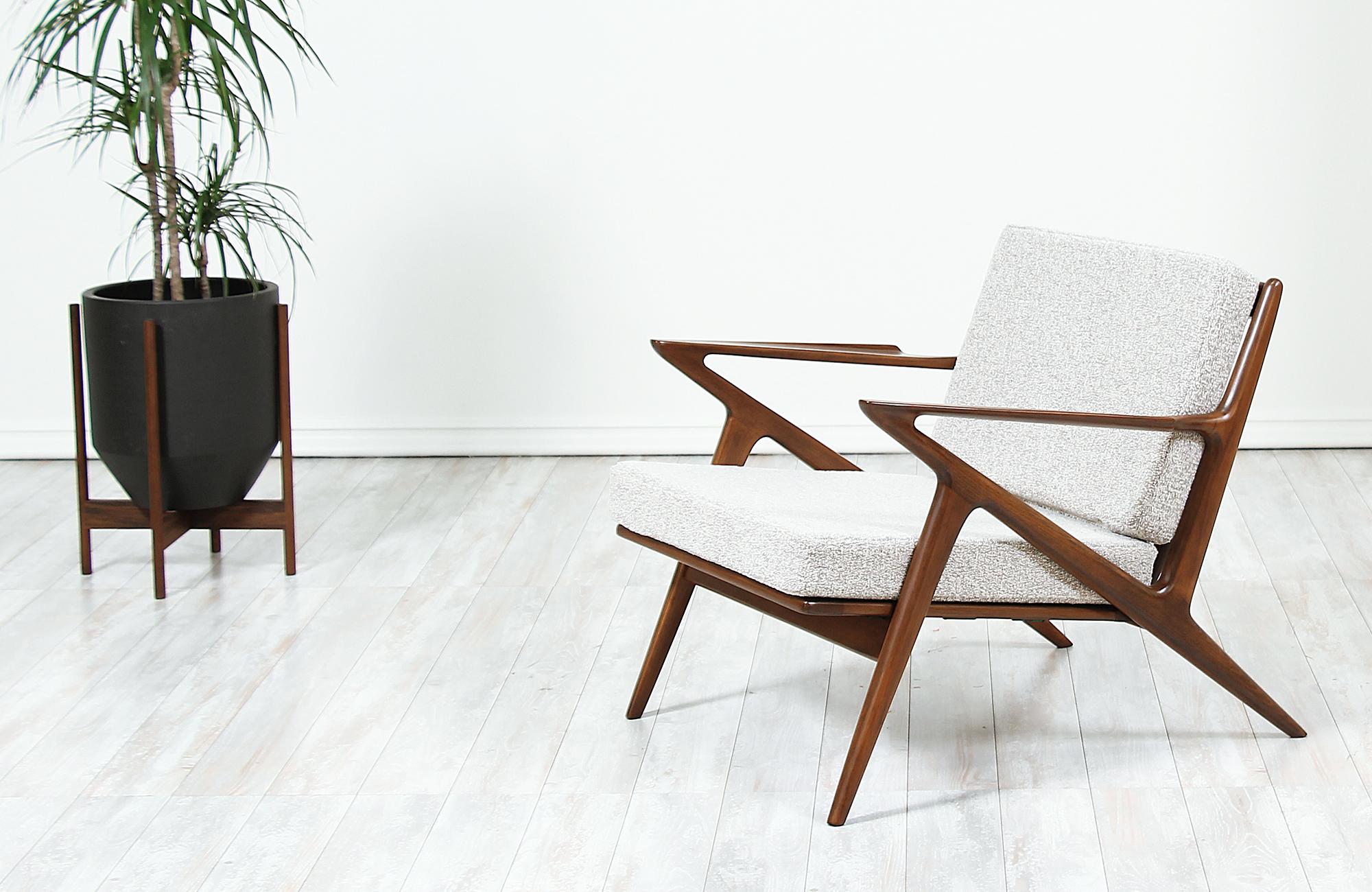 A Classic lounge chair designed by Poul Jensen for Selig in Denmark, circa 1960s. Known as the 'Z' lounge chair for its signature armrests that connect to the legs, which resembles the letter. This iconic chair features a solid walnut-stained