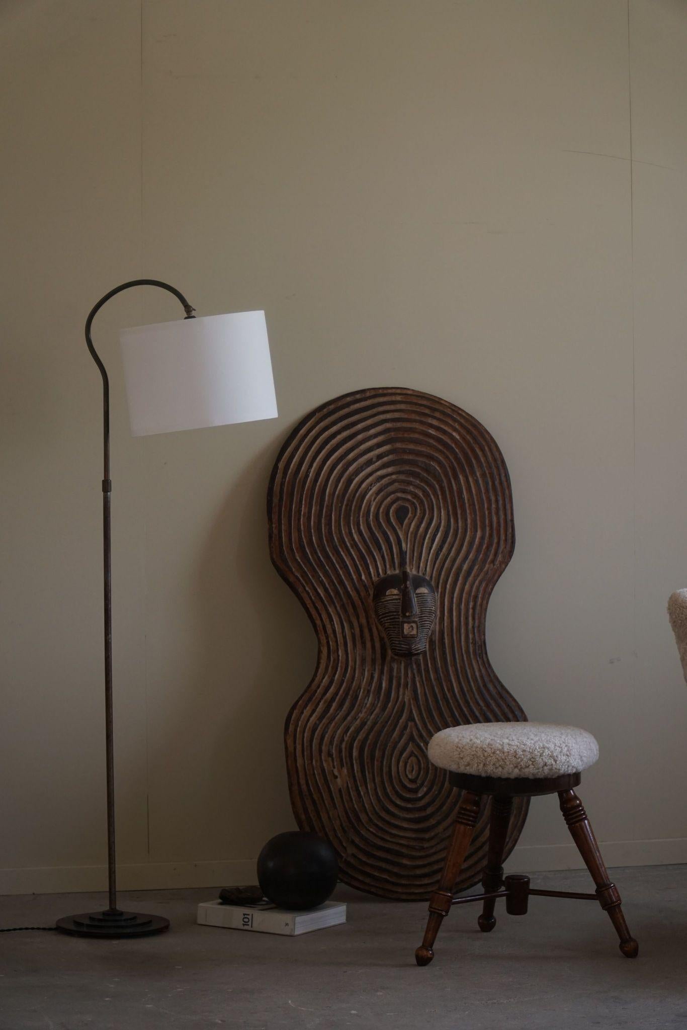 A sleek and minimalist Danish Modernism adjustable floor lamp from the 1950s, crafted in steel with an art deco aesthetic. The design features clean lines and a functional, adjustable body that allows for easy repositioning of the light. 
The steel