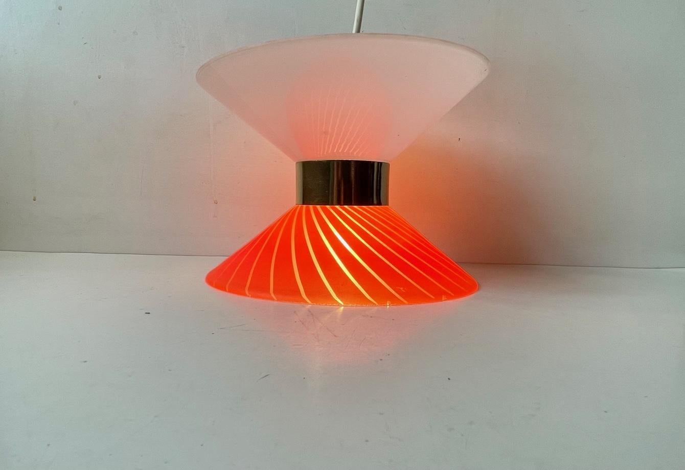 Small Diablo - hour glass shaped opaline and red striped matte glass hanging lamp with center brass disc. Anonymous danish maker/design - circa 1970-80. Measurements: H: 15 cm, Diameter: 20 cm. 3 meters new white wire installed and bulb included.