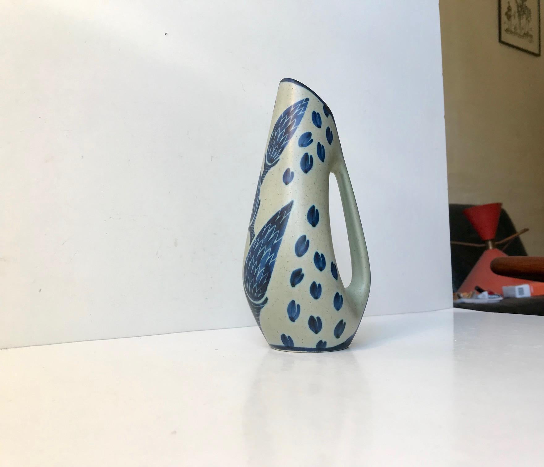 This hand painted ceramic jug vase was designed by the Danish ceramist Einar Johansen and manufactured at Søholm in Denmark during the 1960s. Søholm also made ceramic pieces by Nanna Ditzel and Svend Aage Holm-Sorensen and this jug vase is a flower