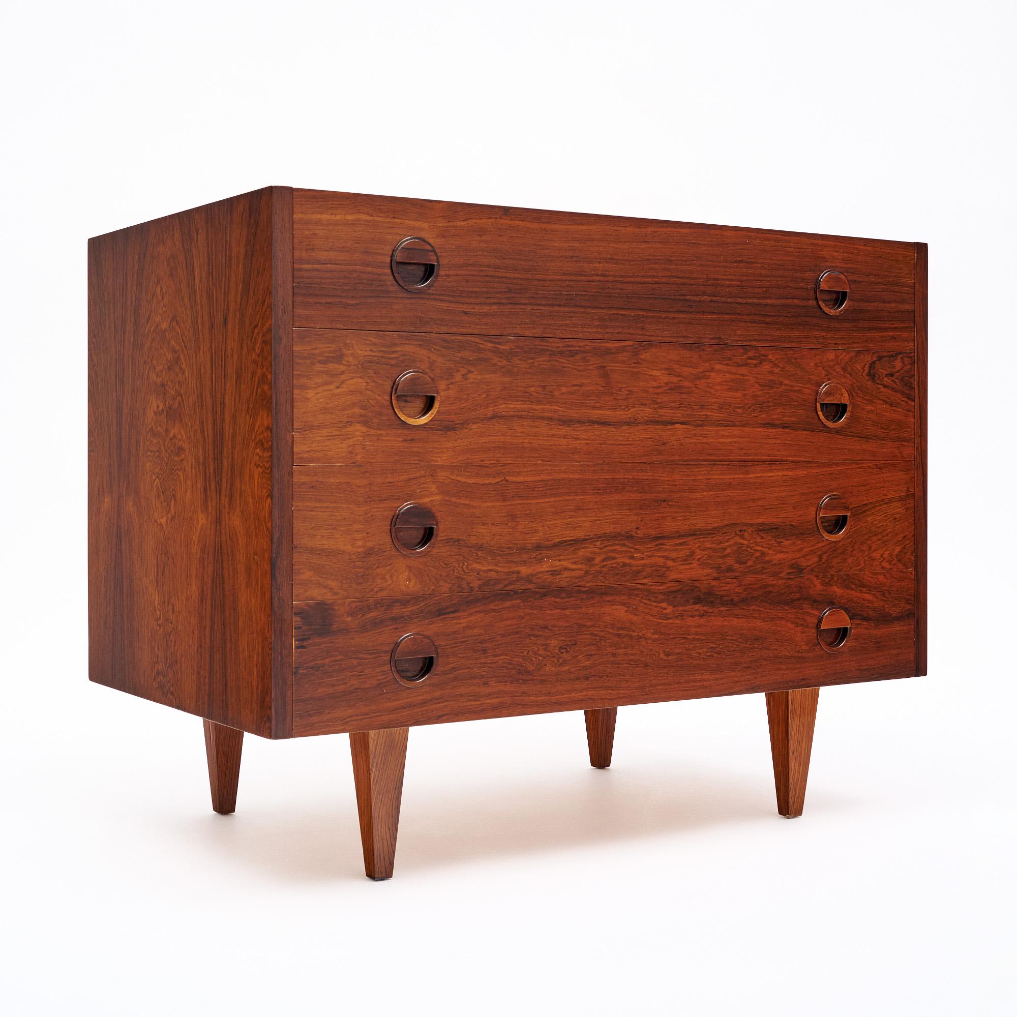 Danish chest from the Modernist era. Made of Brazilian rosewood. Featuring four tapered legs and four dovetailed drawers. This piece is in very nice vintage condition with only minor surface wear consistent with age and use. The photos accurately
