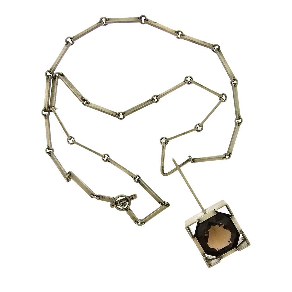 Sterling silver Modernist necklace, circa 1970's, by Danish silversmith Sven Kjeldal, sets a large round octagonal smoky quartz in a sterling box settings. The pendant measures 1-1/4