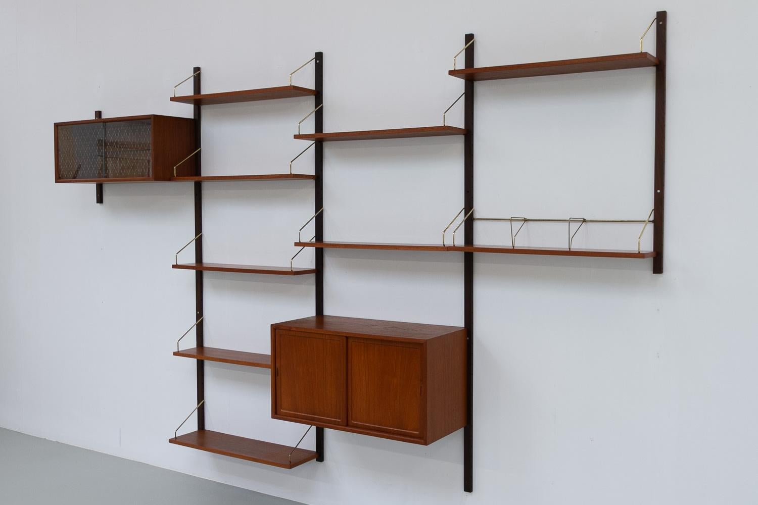 Danish Modular Royal Teak Wall Unit by Poul Cadovius for Cado, 1960s.

Mid-Century Modern 4 bay shelving system model Royal. This is an original vintage floating bookcase designed in 1948 by Danish architect Poul Cadovius. 
Cadovius had the