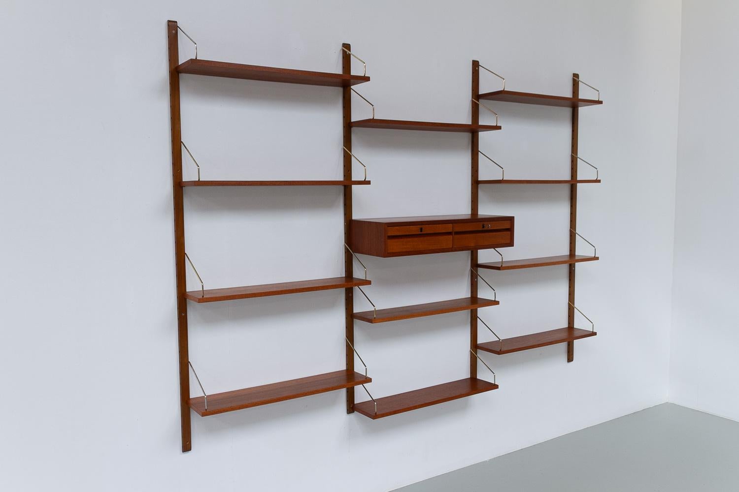 Danish Modular Royal Teak Wall Unit by Poul Cadovius for Cado, 1960s.

Mid-Century Modern 3 bay shelving system model Royal. This is an original vintage floating bookcase designed in 1948 by Danish architect Poul Cadovius. 
Cadovius had the
