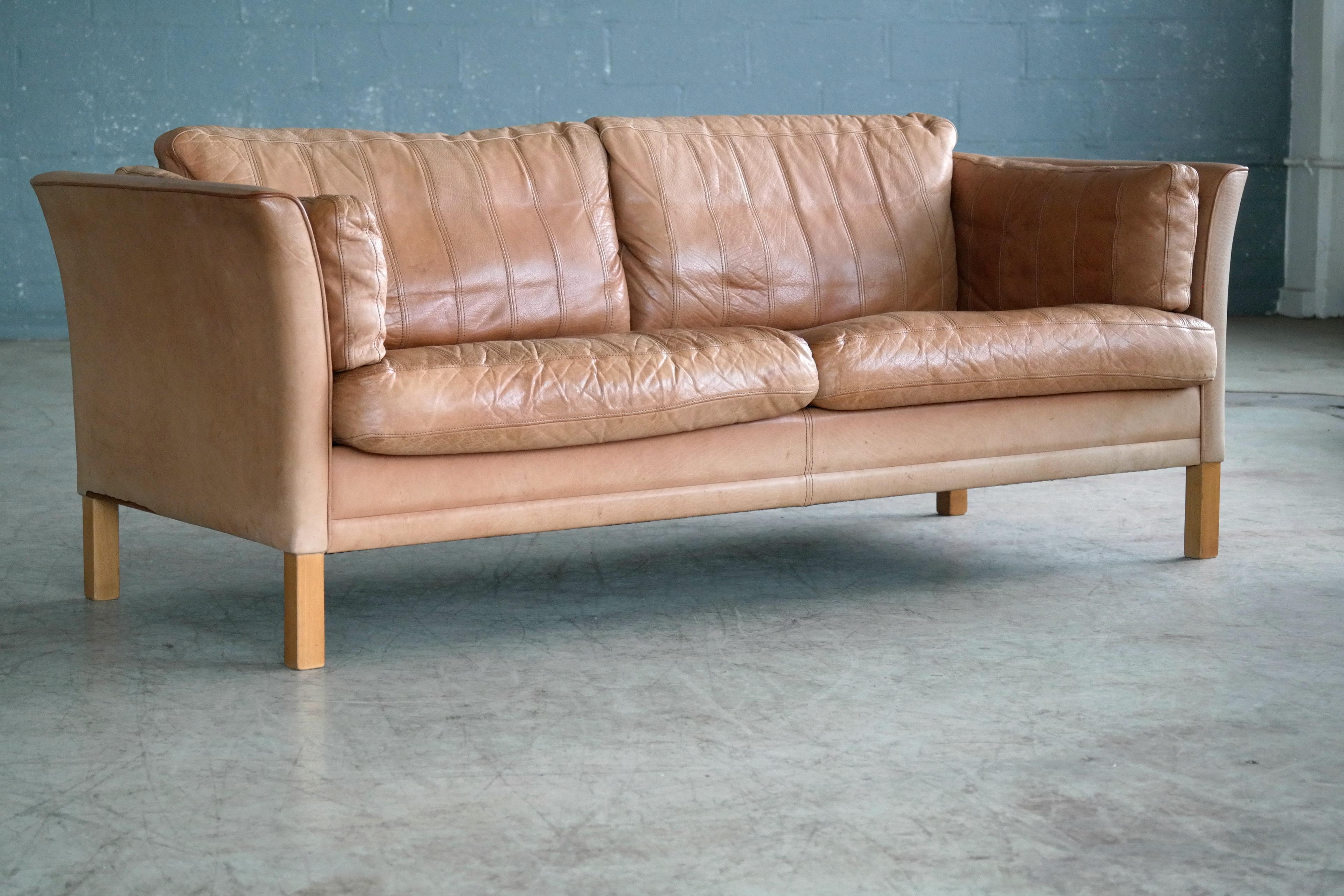 Highest quality craftsmanship Borge Mogensen style sofa in light cognac colored buffalo leather by Mogens Hansen. Thick supple buffalo leather showing great grain just the perfect amount of patina and wear, scuffs and scratches appropriate for its