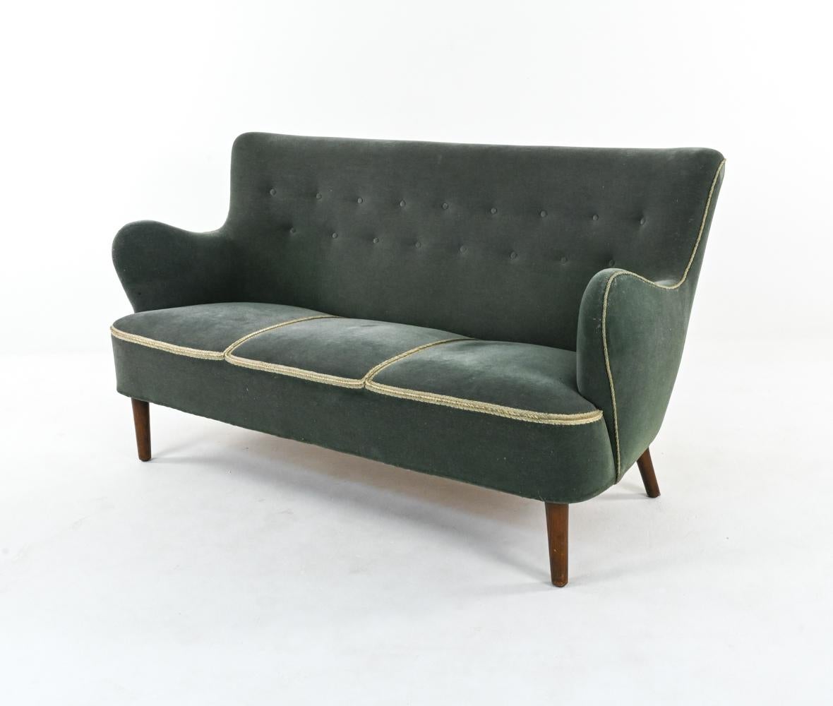 Perfectly proportioned for apartment living, the Mid-Century cocktail sofa is due for a major design comeback. This example by Alfred Christensen features a quintessentially Danish silhouette, with a subtle winged backrest, chunky bench seat and