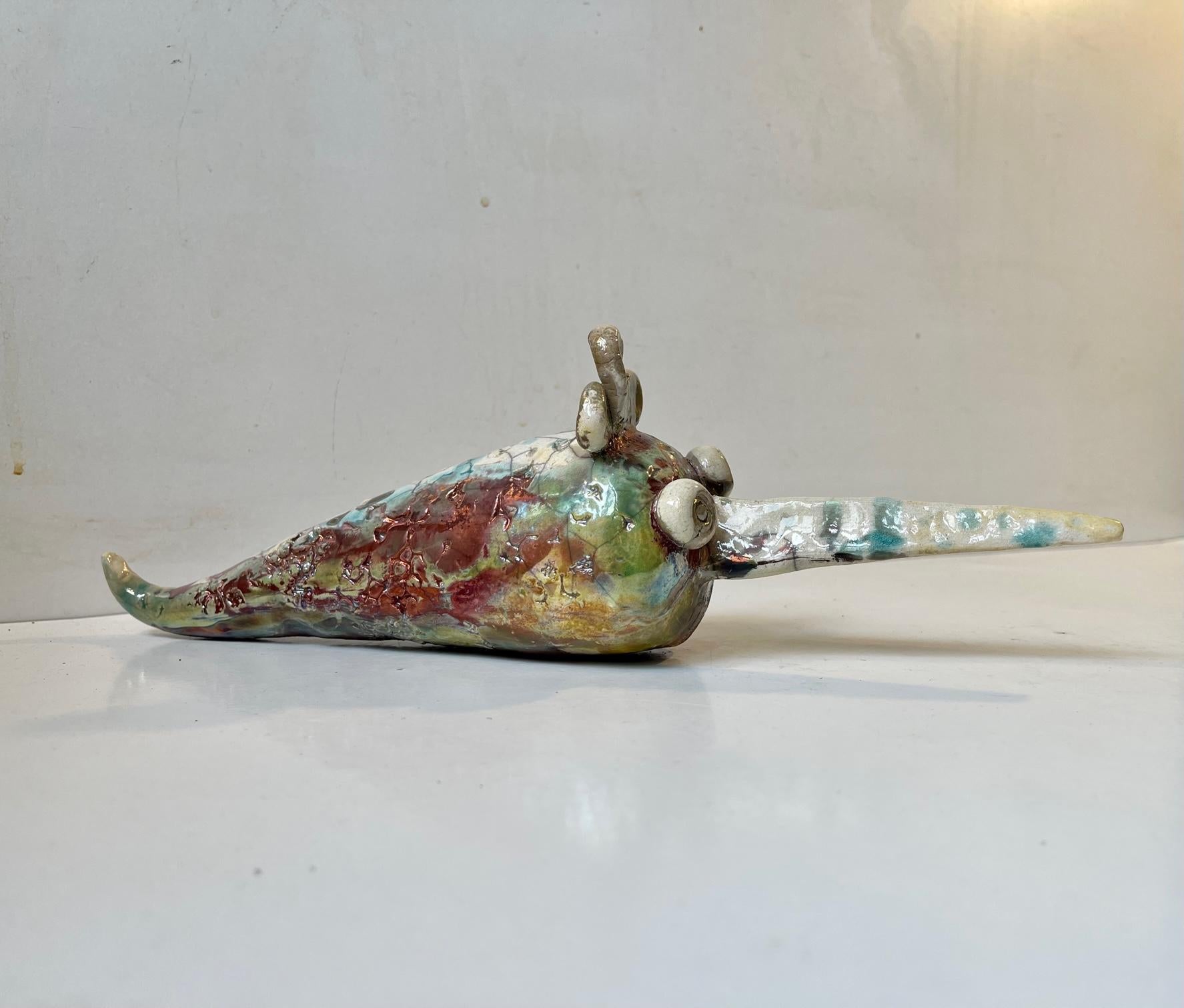 Unique artist/ceramist signed swordfish creatures in Raku burnt stoneware. A vase variety of different glaze colors are on display. Unknown/un-identified Danish ceramist circa 2000 is a style reminiscent of Sten Lykke Madsen. Measurements: L: 32 cm,