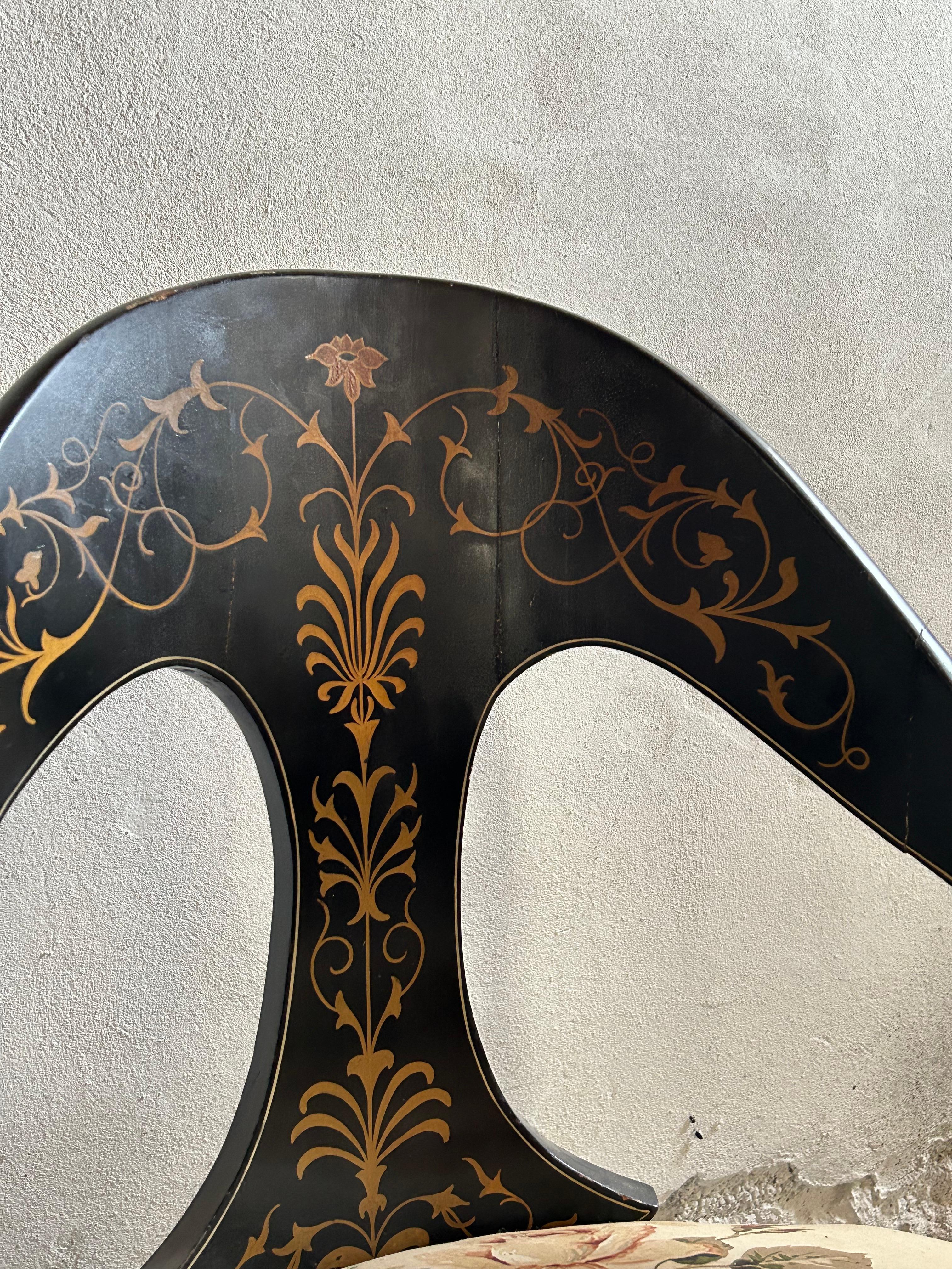 A charming Danish neoclassical chair from the 1860s, featuring its original hand-painted decorations in black and gold. This exquisite piece showcases the refined craftsmanship and elegant ornamentation typical of the neoclassical style, with