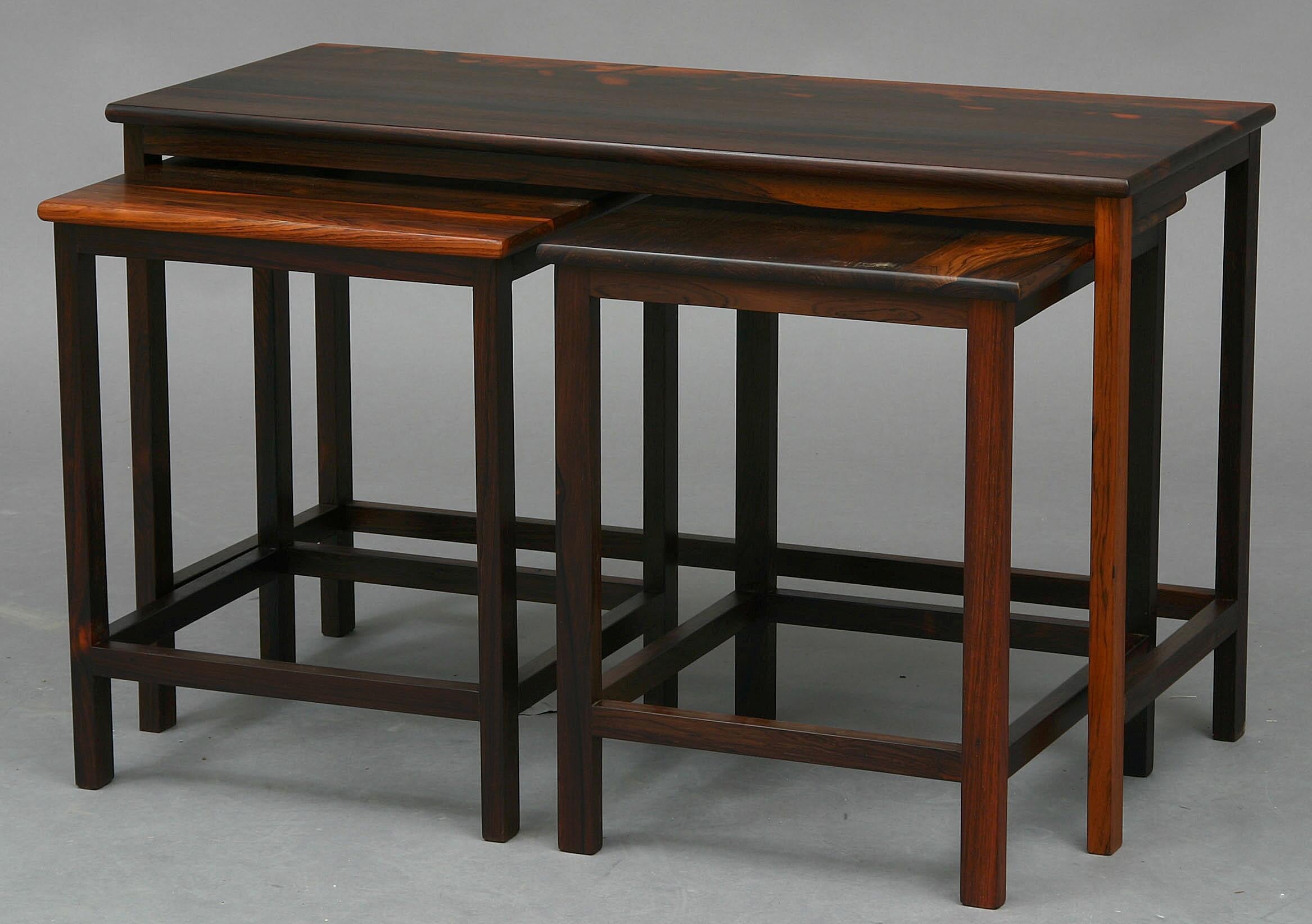 Danish furniture maker: Three nest of tables in solid rosewood. Large table H. 53. L. 87. W. 38 cm. The other tables H. 49. L. 40. W. 38 cm. (3)
