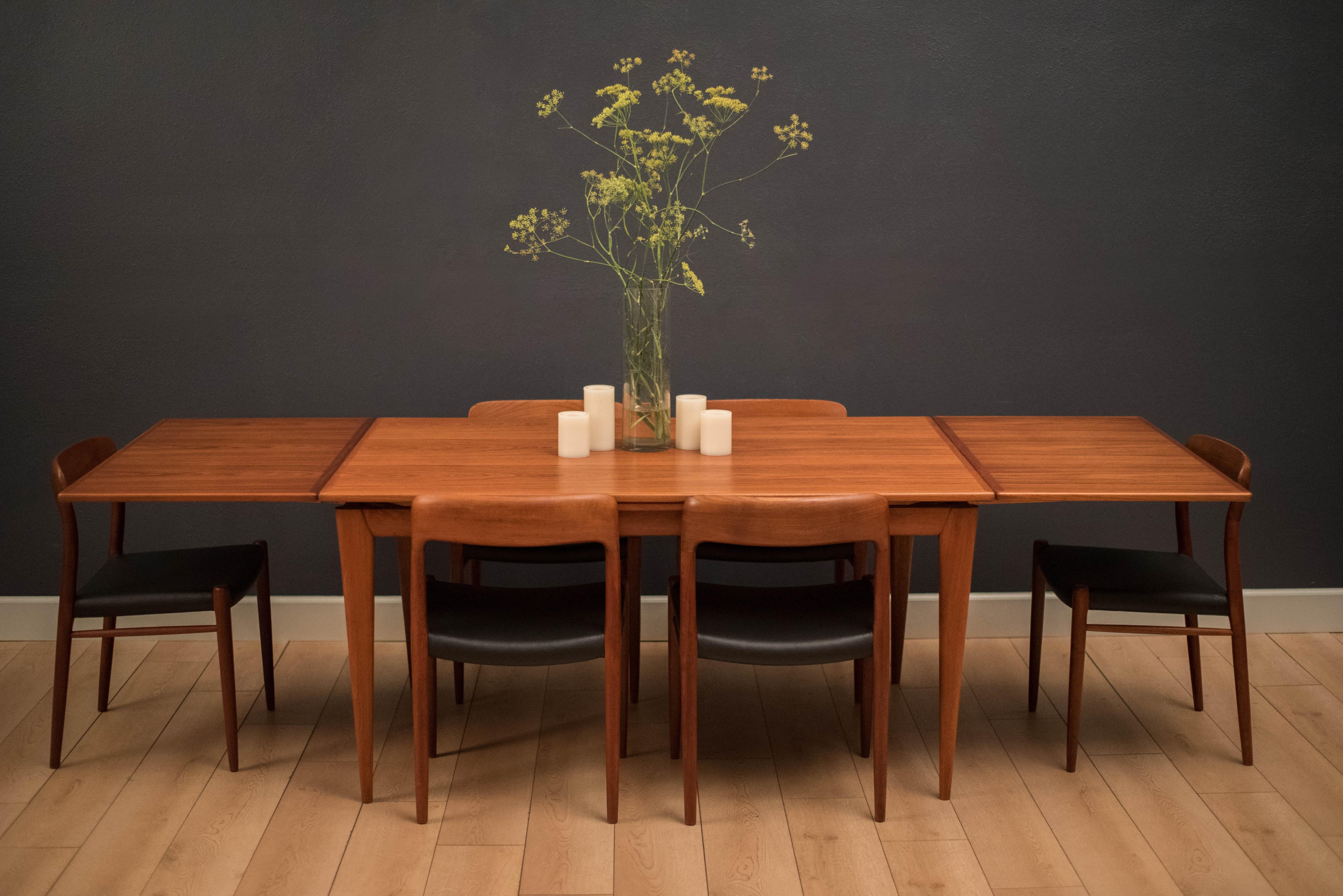 Mid century teak draw leaf dining table by Niels Otto Moller for J.L. Moller. This piece features thick tapered legs and includes two leaves that store underneath table.

Dimensions: 105