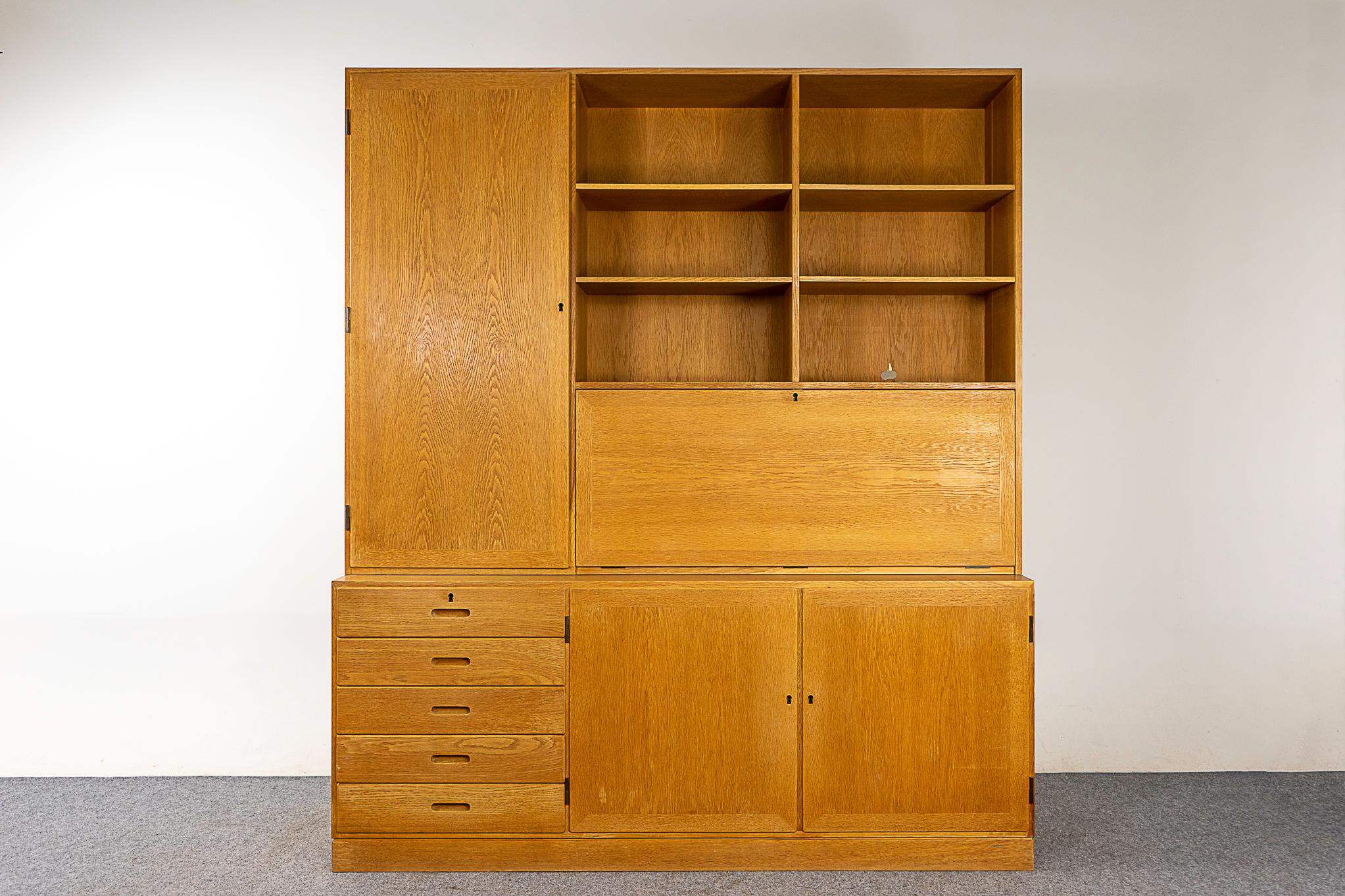 Oak Danish bookcase cabinet by Kai Winding, circa 1960's. Impressive, highly functional bookcase combines open shelving, exterior drawers, cabinetry and a drop down desk with a fitted interior! Anything and everything all in one place. Danish