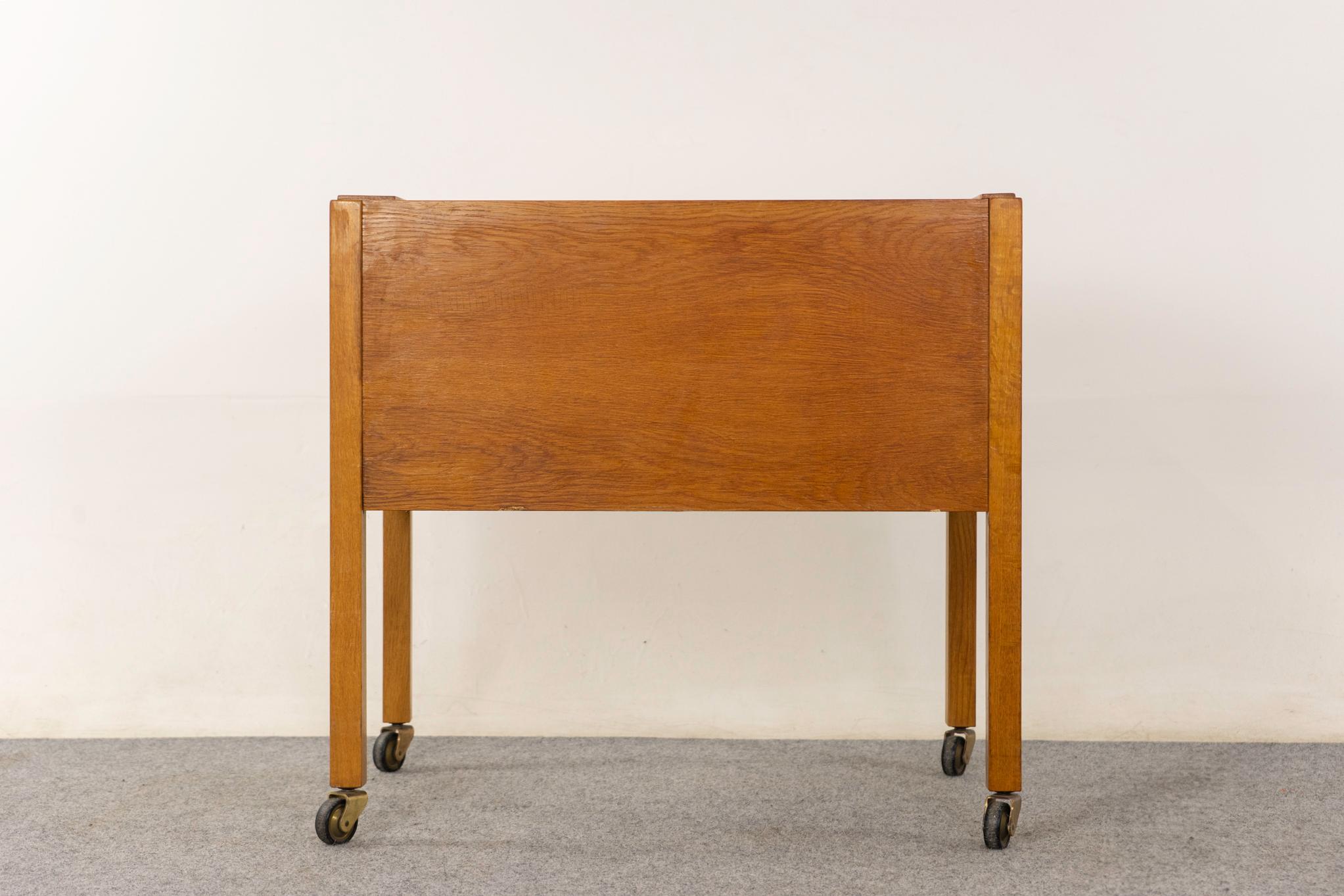 Oak Danish file cabinet, circa 1960s. Smooth operating tambour door rolls open to cubby with hanging file system. Roll it to where you need it!  

Unrestored item with option to purchase in restored condition for an additional $200 USD. Restoration