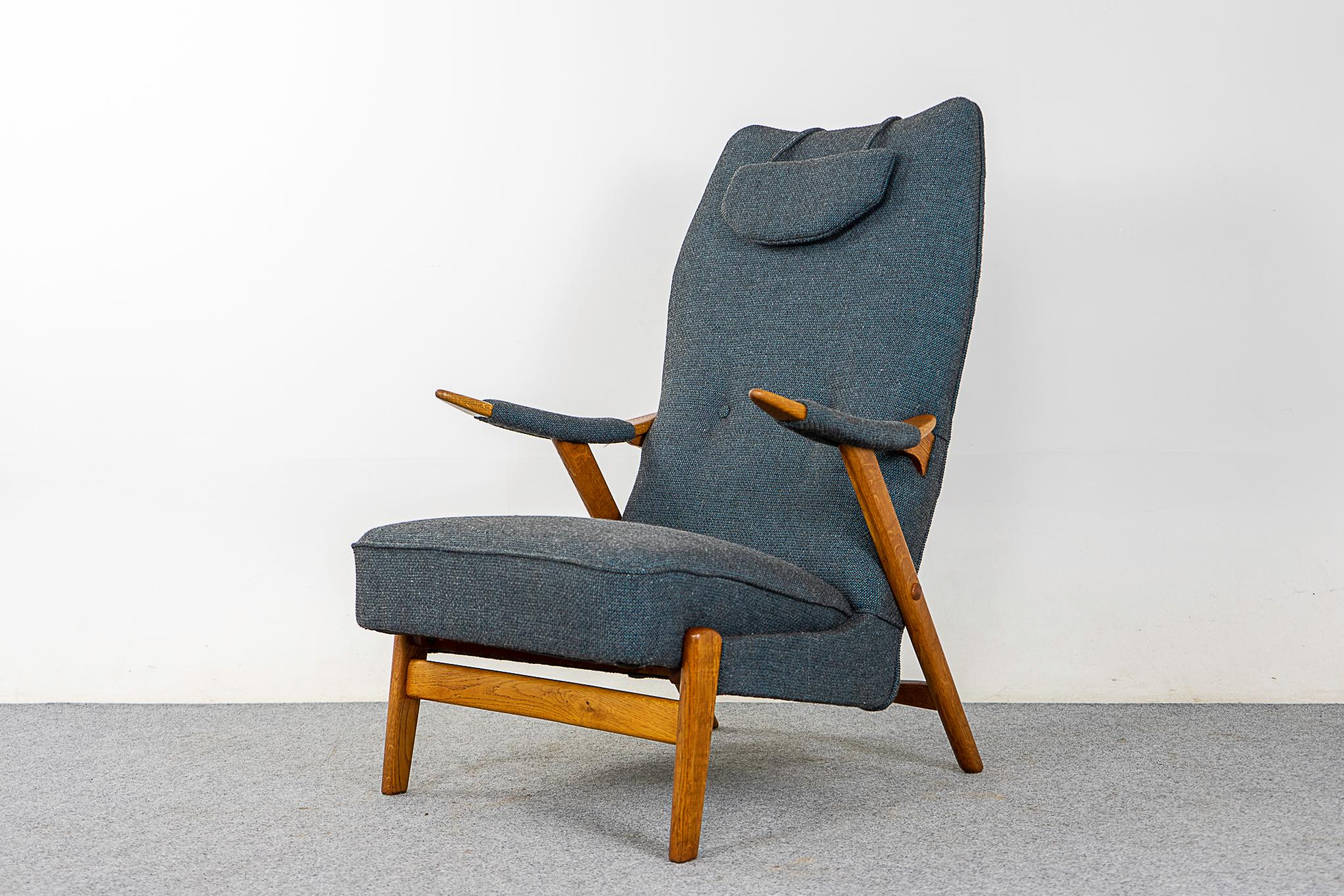 Oak lounge chair, circa 1960's. Sculptural frame with high back and neck pillow, a very comfortable sit. Beautiful new upholstery in grey/blue textured wool. Stunning!   