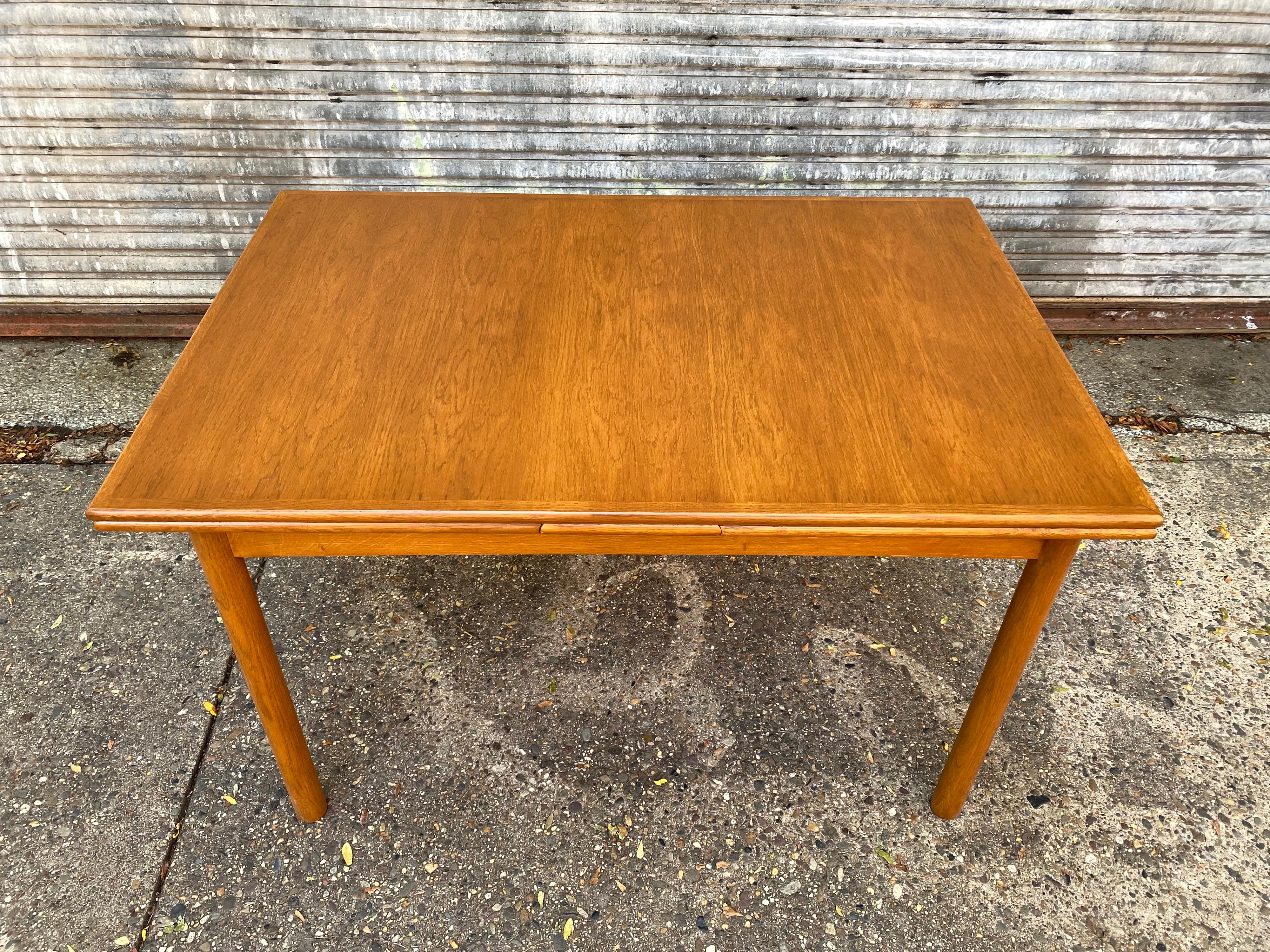 Danish refractory oak dining table. Newly refinished and ready to go! Little harder to find in Oak, looks great mixed with teak chairs or rosewood! Nice smaller size and scale! Leaves pull out easily. Table when fully extended is 89.5 long and 33.5
