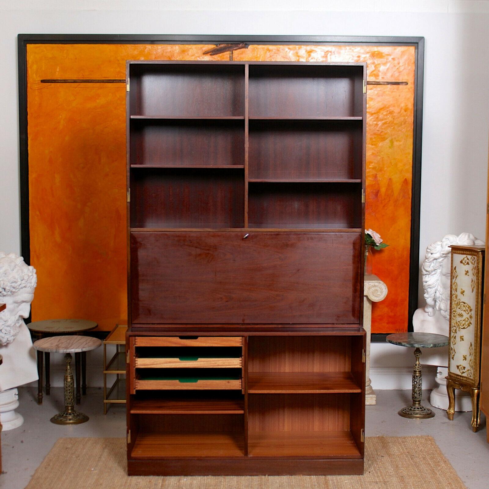 An impressive bureau bookcase by Danish makers Omann Jun.
The removable doors lift out of the brass hinges and enclosed fitted interiors briefly comprising shelving, drawers and baize lined trays.
Dismantles to two sections for ease of movement.