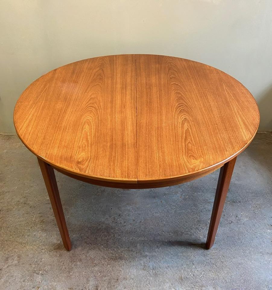 A beautiful Danish Model 55 teak dining table designed by Gunni Omann for Omann Jun Møbelfabrik, this would make a stylish addition to any dining or work area. A striking piece of classically designed Scandinavian furniture.

The table has two