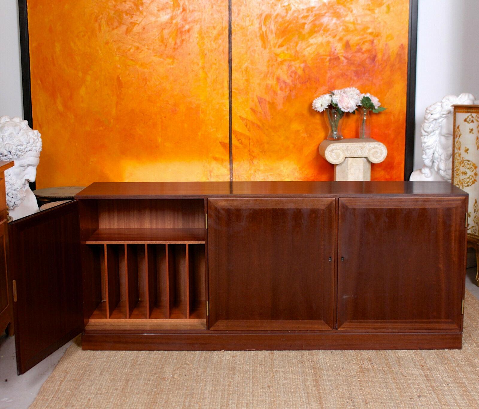 An impressive rosewood sideboard by Danish makers Omann Jun.

The doors enclosed fitted interior for records and adjustable shelving, raised on a plinth base.

Some scratches, primarily to sides.

Denmark, circa 1970.