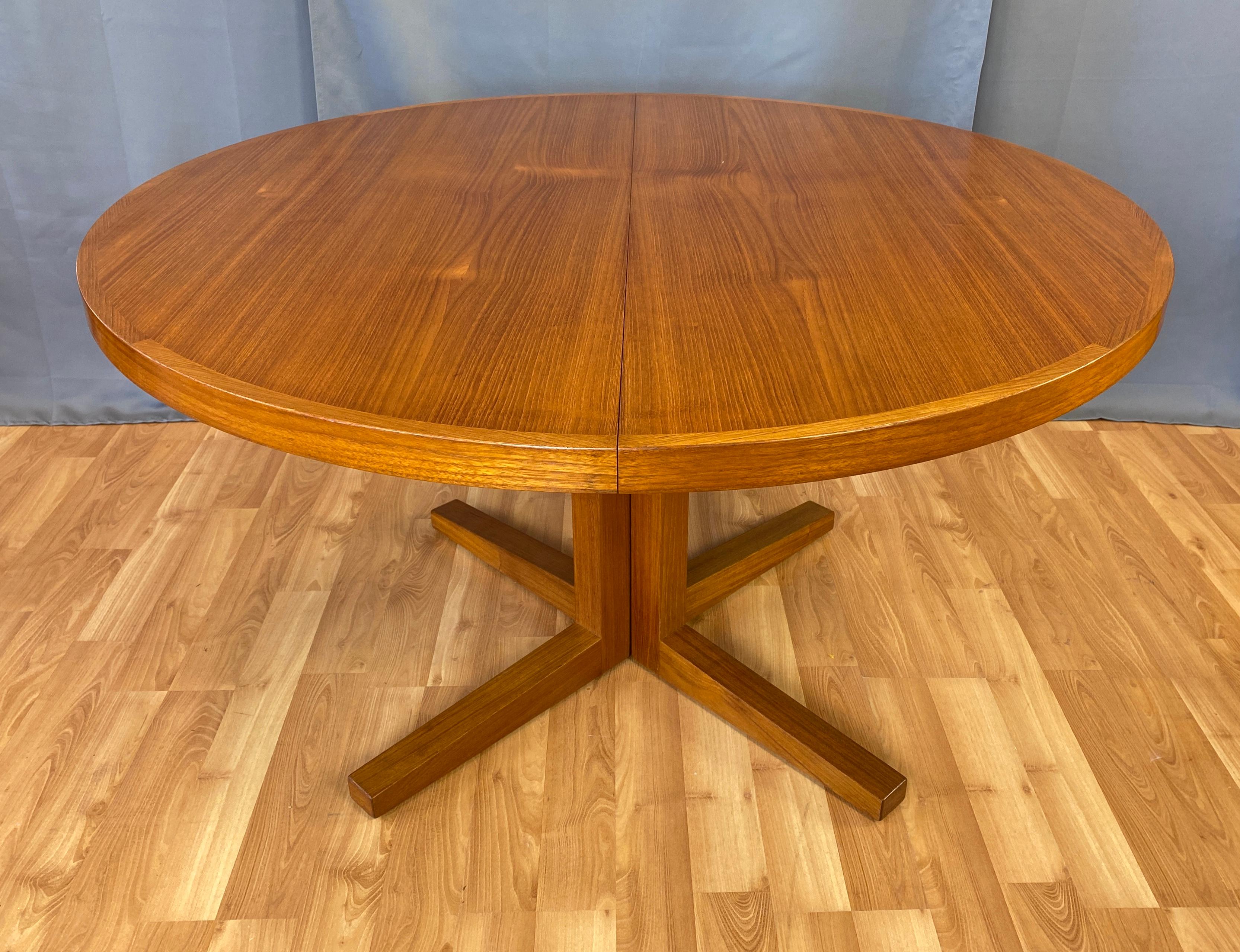 Offer here is a handsome teak dining table designed by John Mortensen for Heltborg Møbler, circa 1960s.
Starts off with central pedestal, and round top, when leaves are added the pedestal splits in half and each leaf turns into a larger