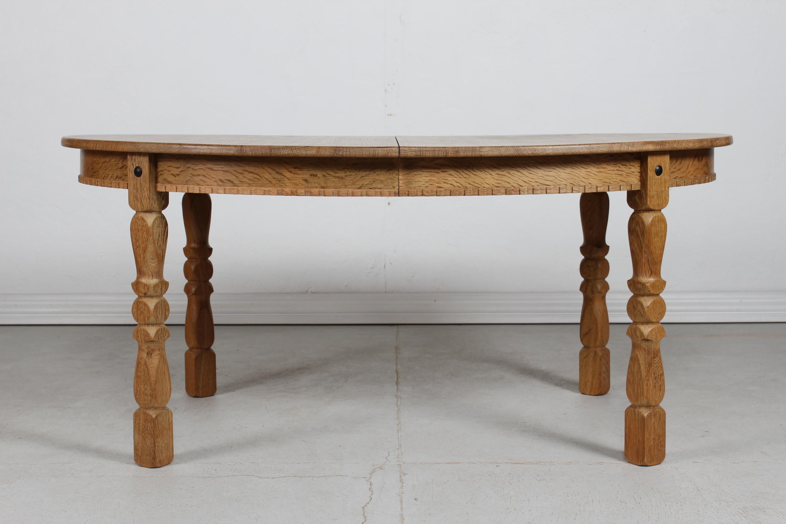 Mid-Century Modern Danish Oval Extendable Dining Table of Oak in Henning  Kjærnulf Style 1970s For Sale