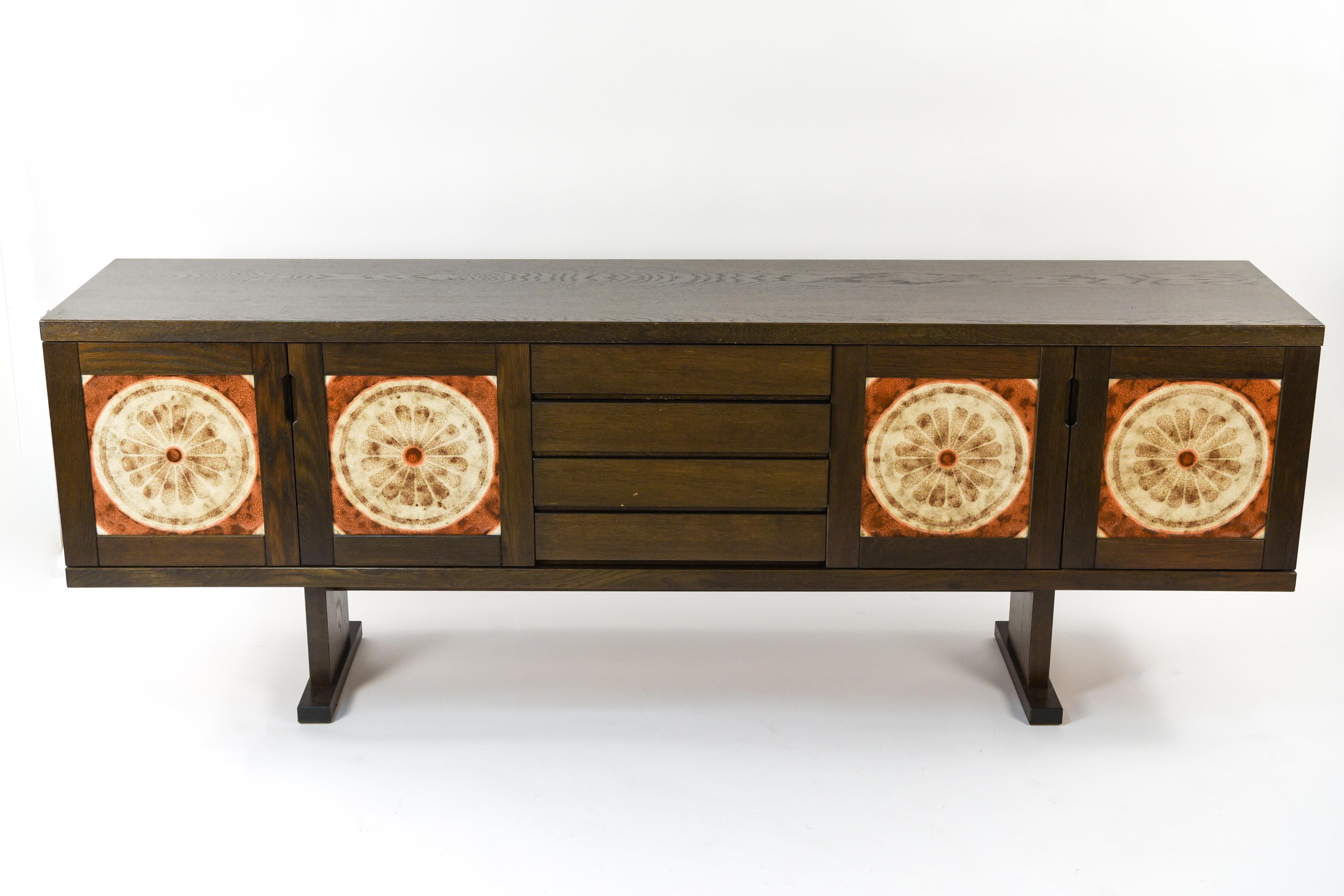 This is a fabulous sideboard in dark oakwood made by Skovby, circa 1970s. This piece features ceramic 