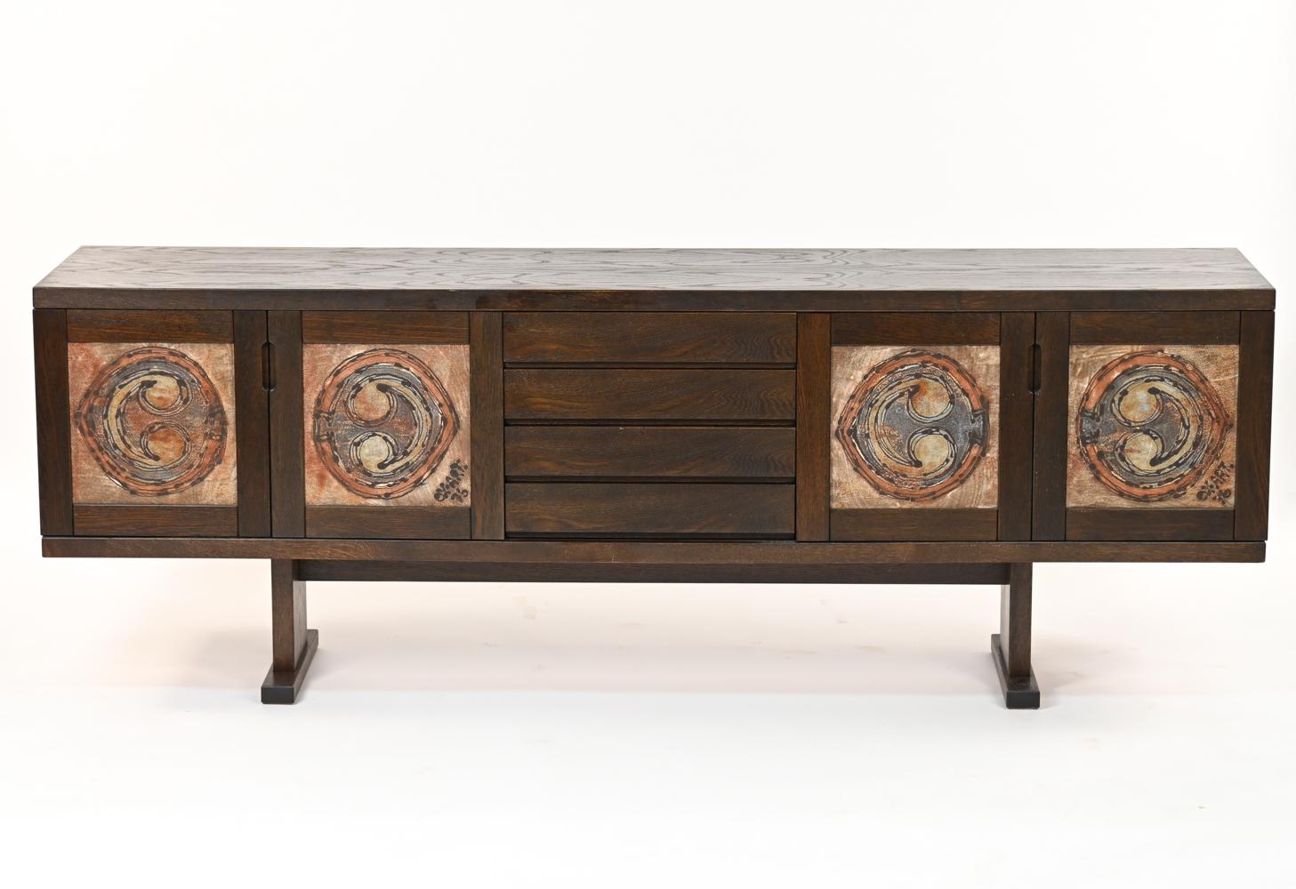 This is a fabulous sideboard in dark stained oakwood made by Skovby, circa 1970s. This piece features ceramic 