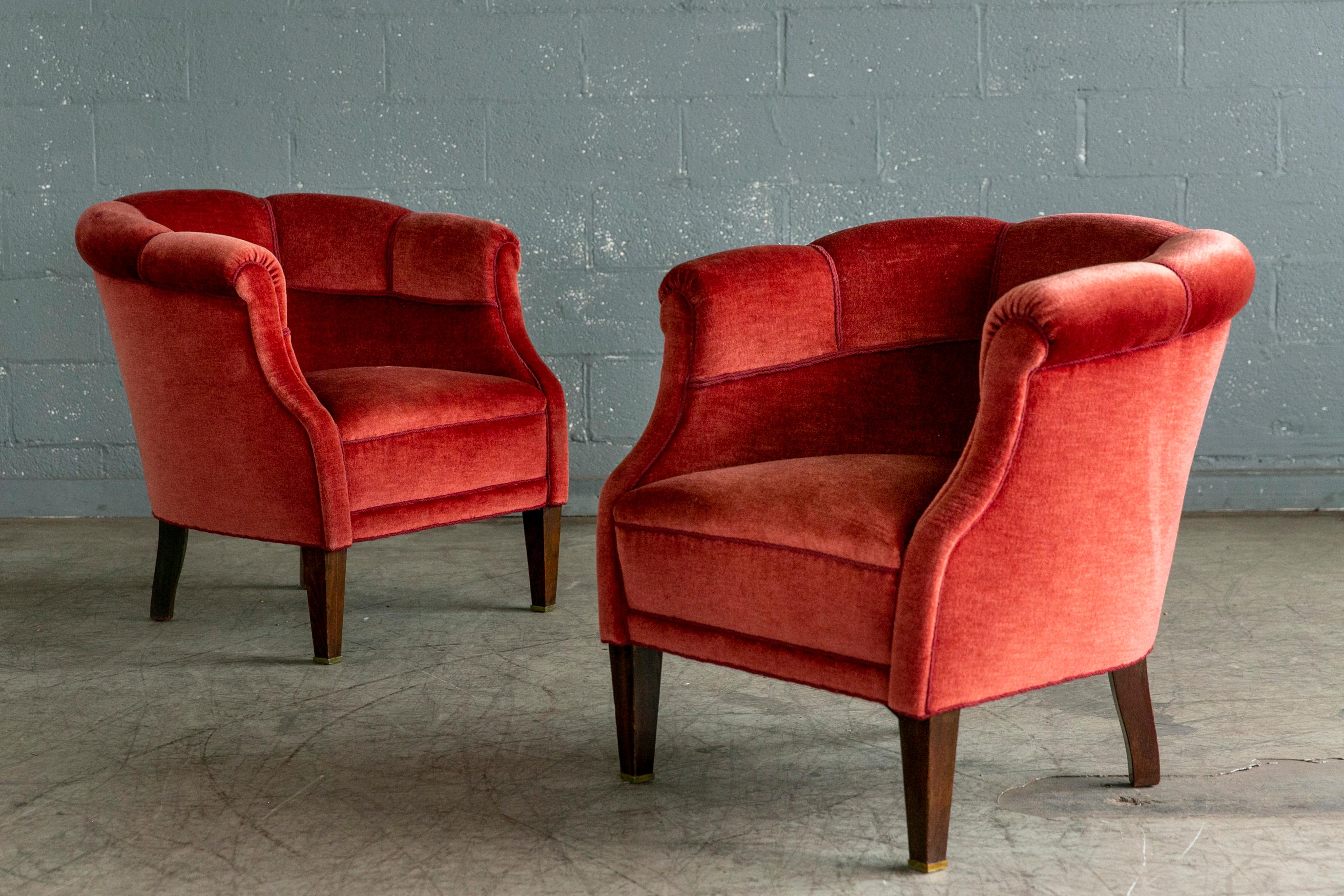 Comfortable, exuberant, and ultracool pair of Danish lounge chairs from the 1940's. We love the curved backrests and low slung organic proportions and taller less chunky mahogany legs adding a bit more elegance. The mohair fabric is in still clean