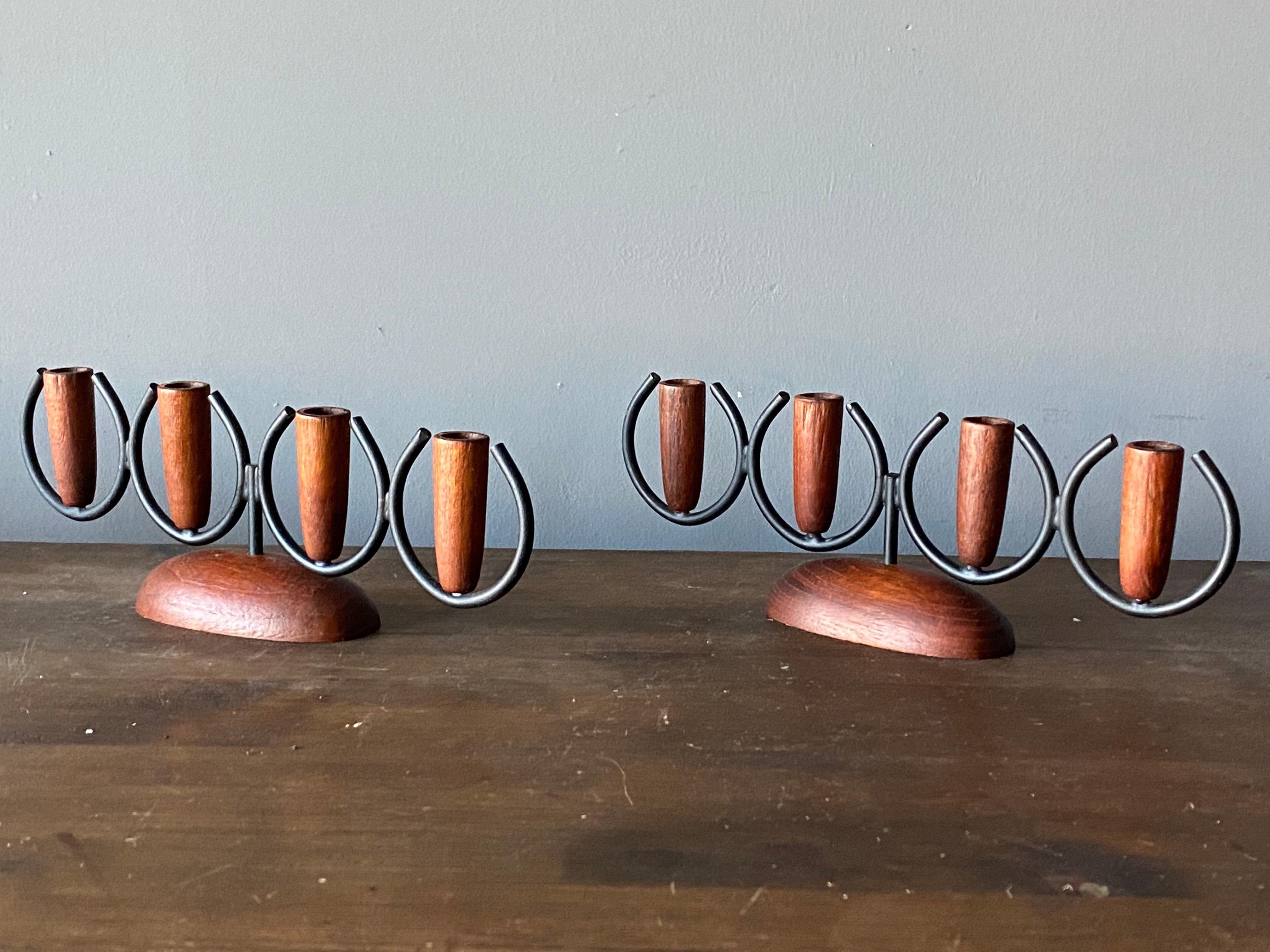 A pair of candelabras, in painted metal and solid teak. Denmark, 1950s

Other designers of the period include Piet Hein, Paavo Tynell, Josef Frank, and Jean Royère.

  