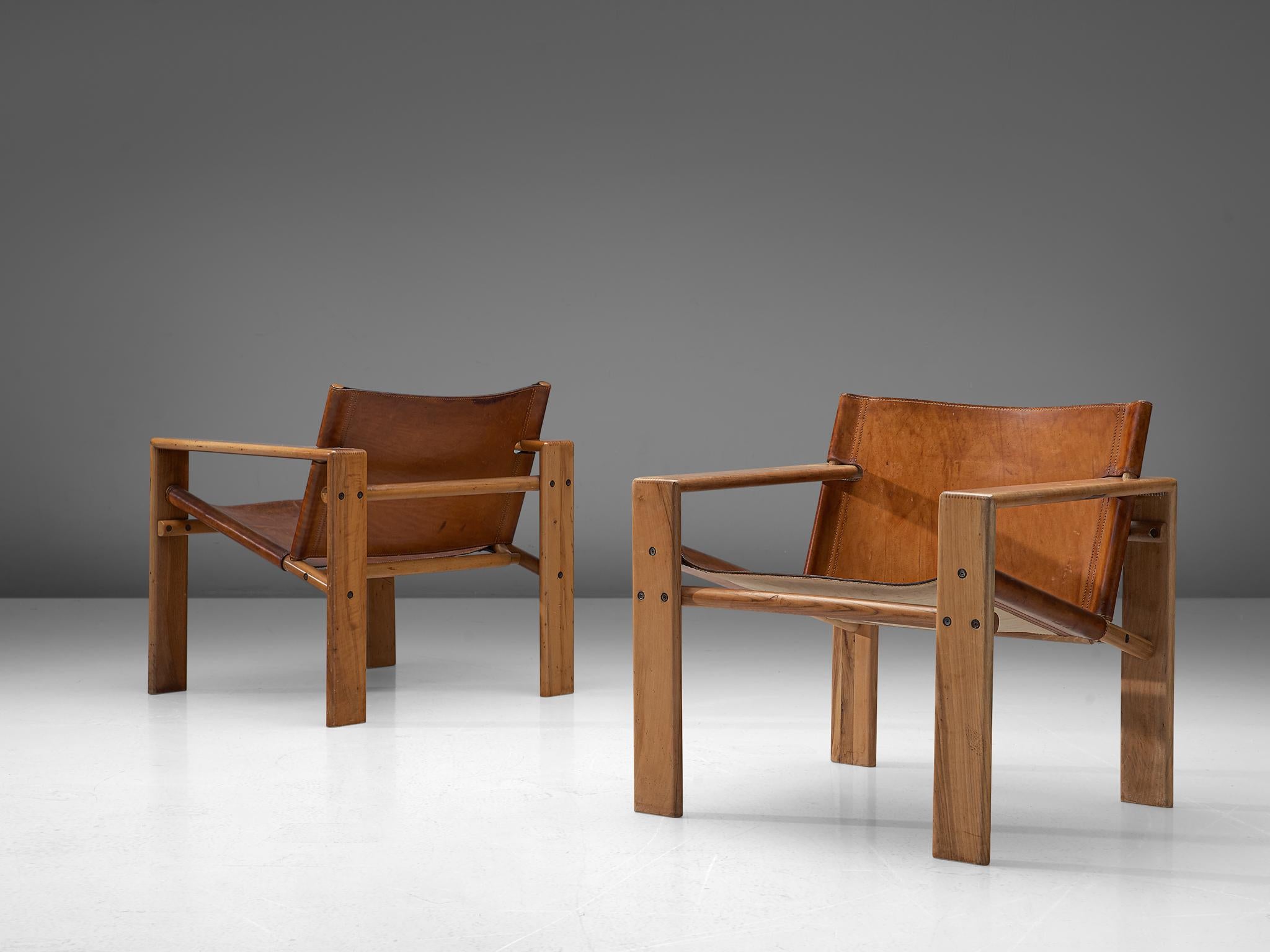 Tarcisio Colzani, set of two armchairs, in cognac leather, elm, Italy, circa 1965.

These comfortable armchairs in elm and cognac saddle leather feature a wonderful and rich patina and is therefore especially interesting as the aging of the leather