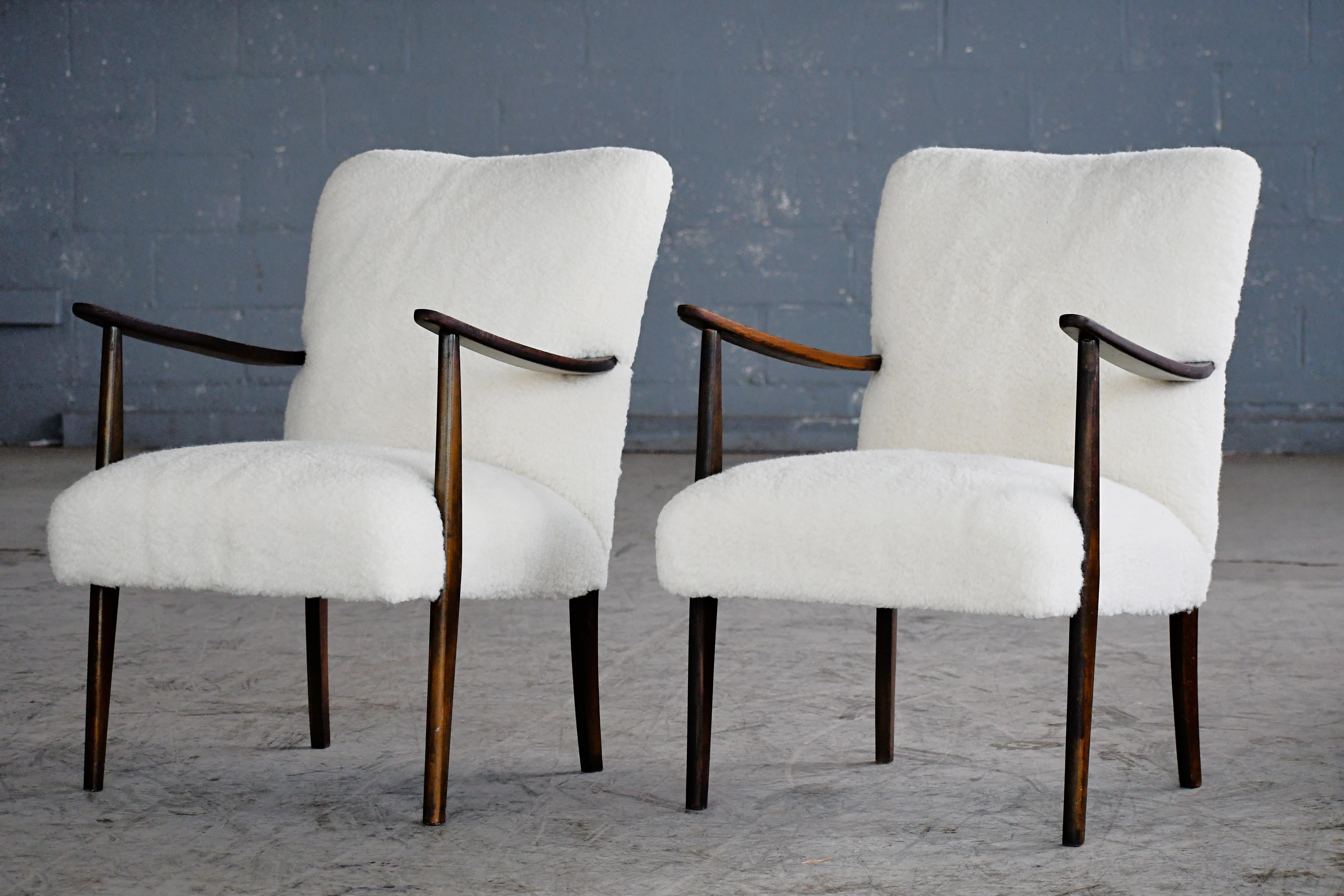 Lovely elegant Danish easy style chairs probably made around 1950. These chairs are very early examples of the style that became the famous Danish easy chair of the 1950s and 1960s in the tradition of Arne Vodder and Hans Wegner. The wood from