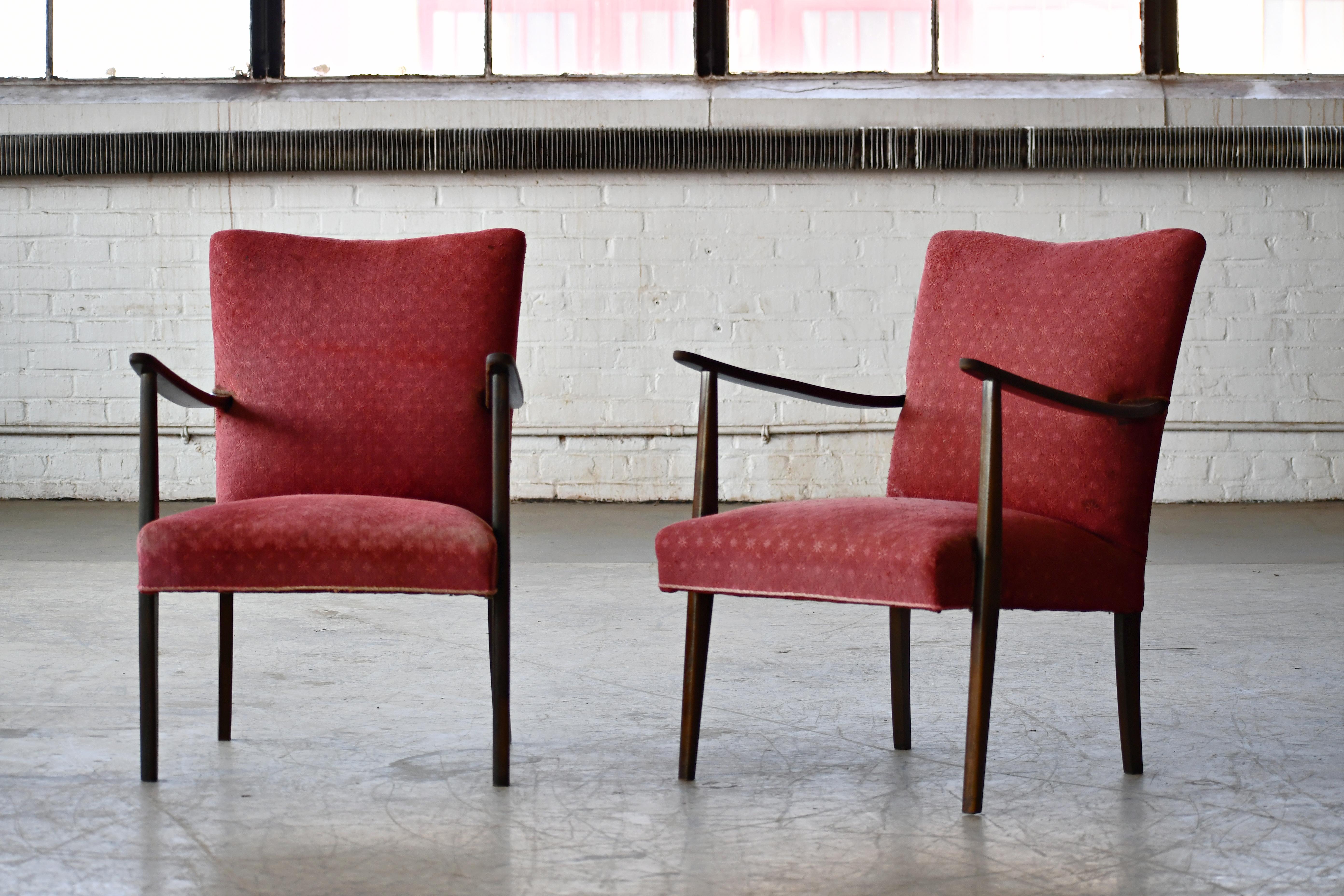 Lovely elegant Danish easy style chairs probably made around 1950. These chairs are very early examples of the style that became the famous Danish easy chair of the 50's and 60's. The wood from stained beech which indicates that they were made