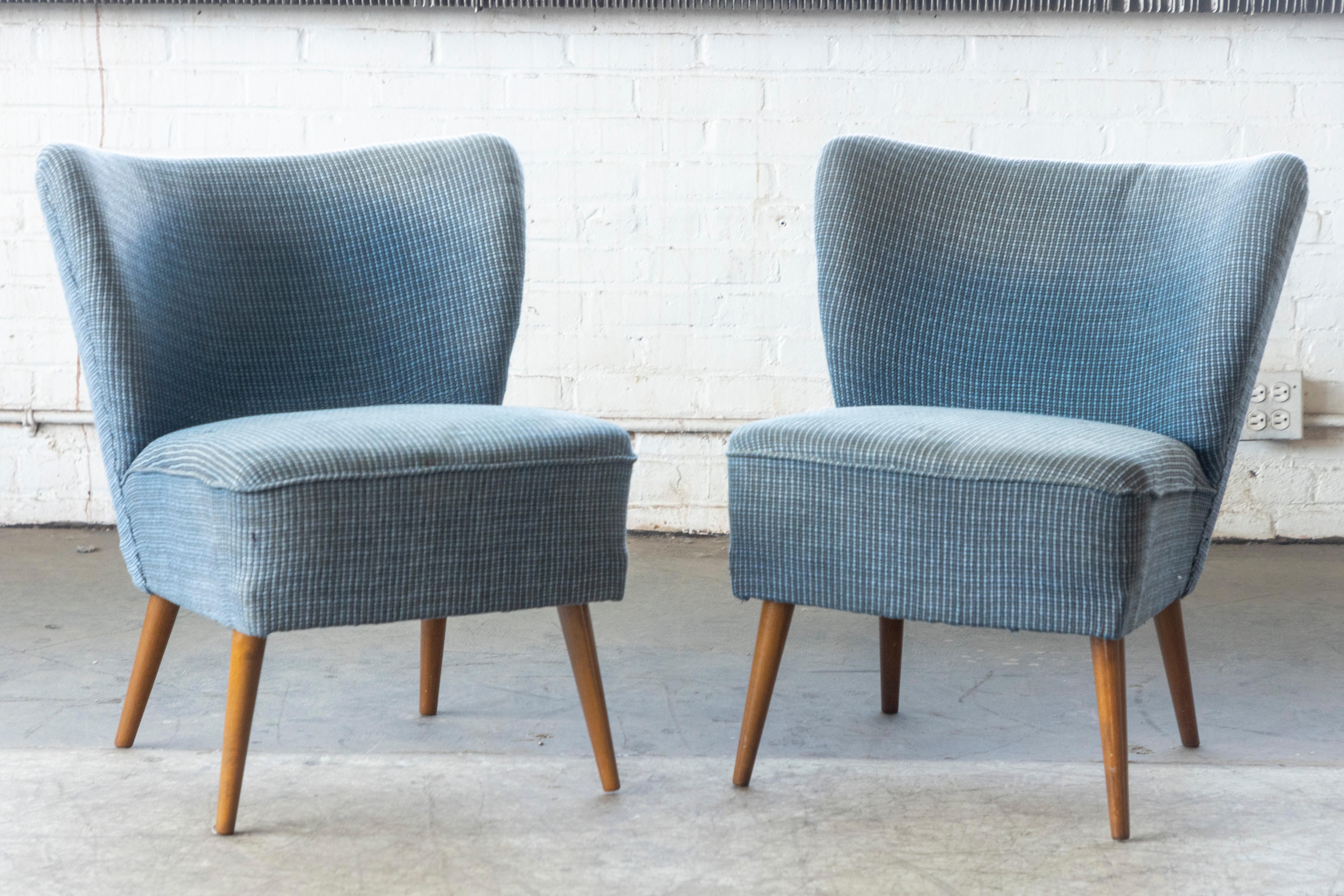 A very cool matching pair of Danish slipper or cocktail chairs from the 1950s. Very comfortable and light weight and thus easy to move around when the situation and guests require extra seating. Well crafted sturdy construction. Needs new upholstery