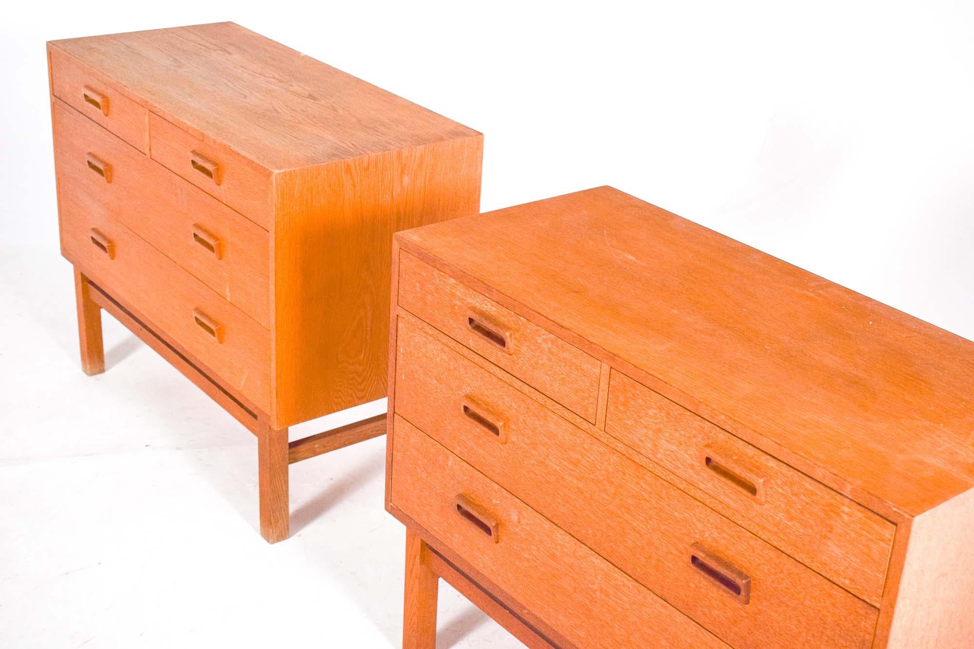 Nice vintage pair of chest of drawers made of veneered oak original. Designed by Holger Jensen for FDB. Made in Denmark from the 1960s. Front with two small and two large drawers. Solid oak frame. In very well condition and refinished by us when it