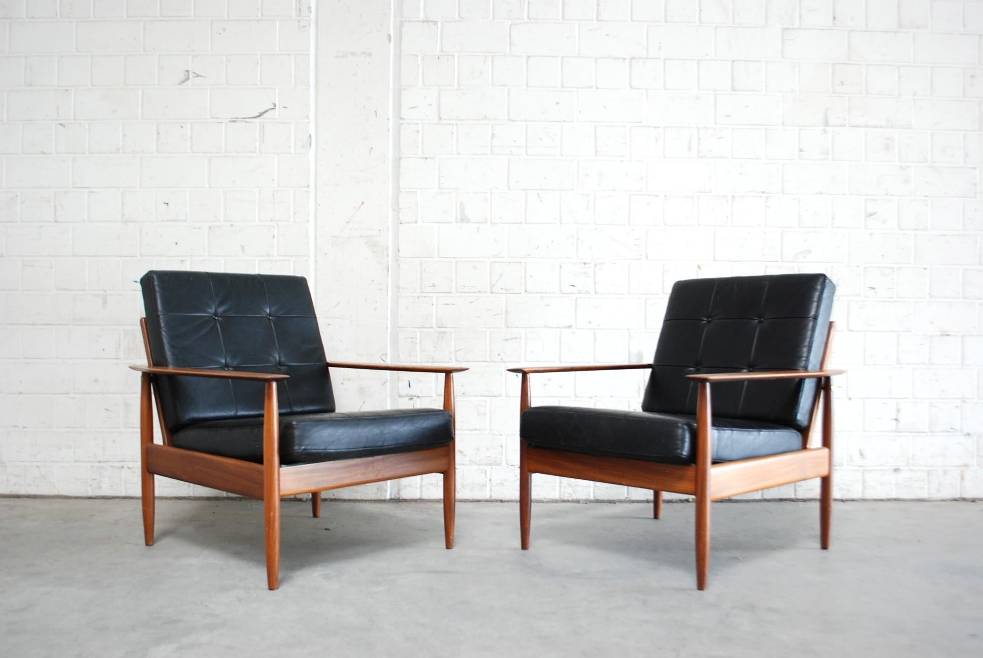 Danish pair of leather armchairs from 1960s.
Black aniline leather and teakwood with nice brass details.
