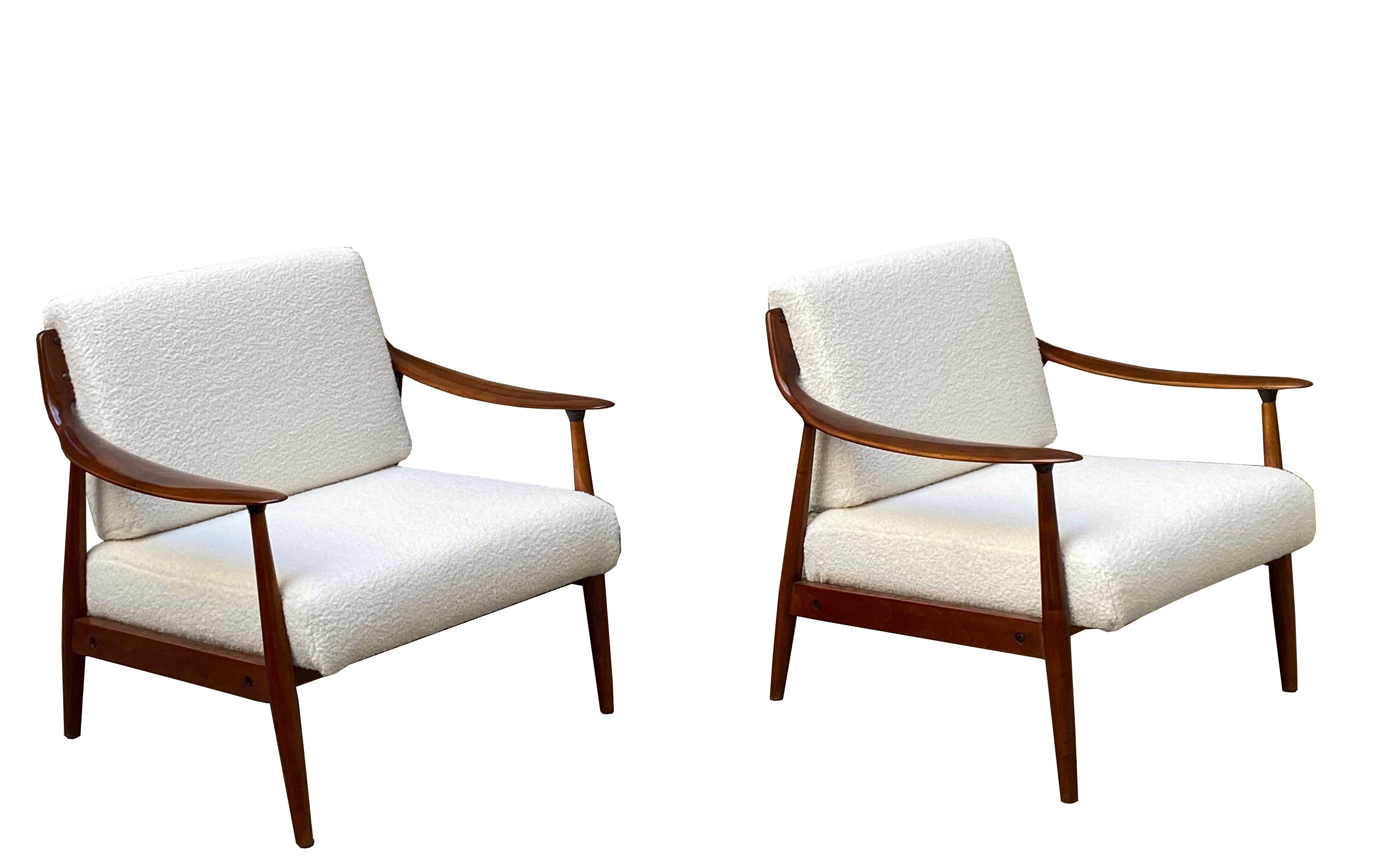 Pair of comfortable and impressive Danish armchairs with minimalist teak frame and wide upholstered seat and back.
The frame and legs are made of solid wood. The small details not only add to the originality and unique character of this piece of