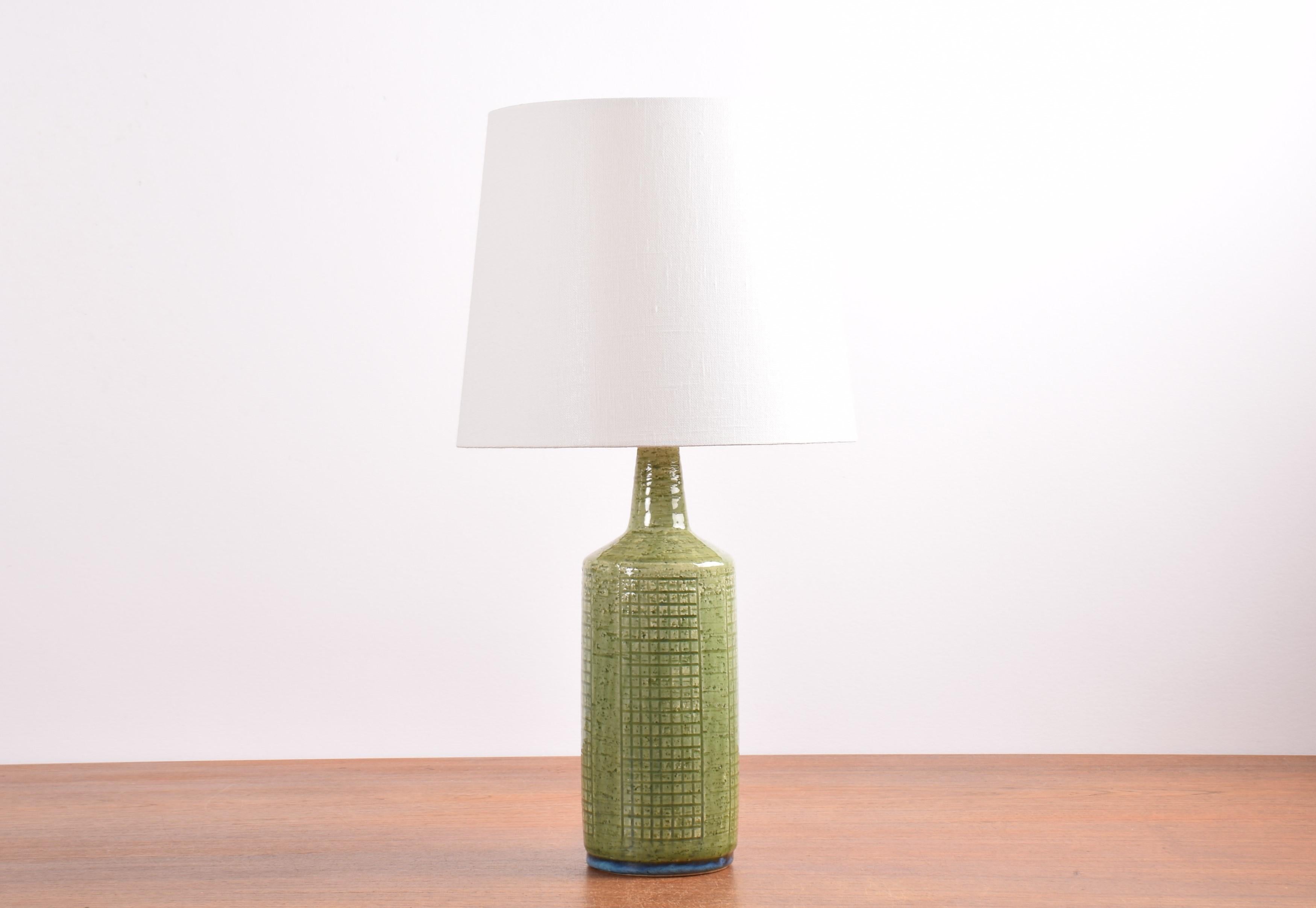 Midcentury table lamp from Danish Palshus including lampshade.
The lamp was designed by Per Linnemann-Schmidt and made circa 1960s.
It is made with chamotte clay which gives a rough and vivid surface. The glaze is grass green with a brigt blue rim