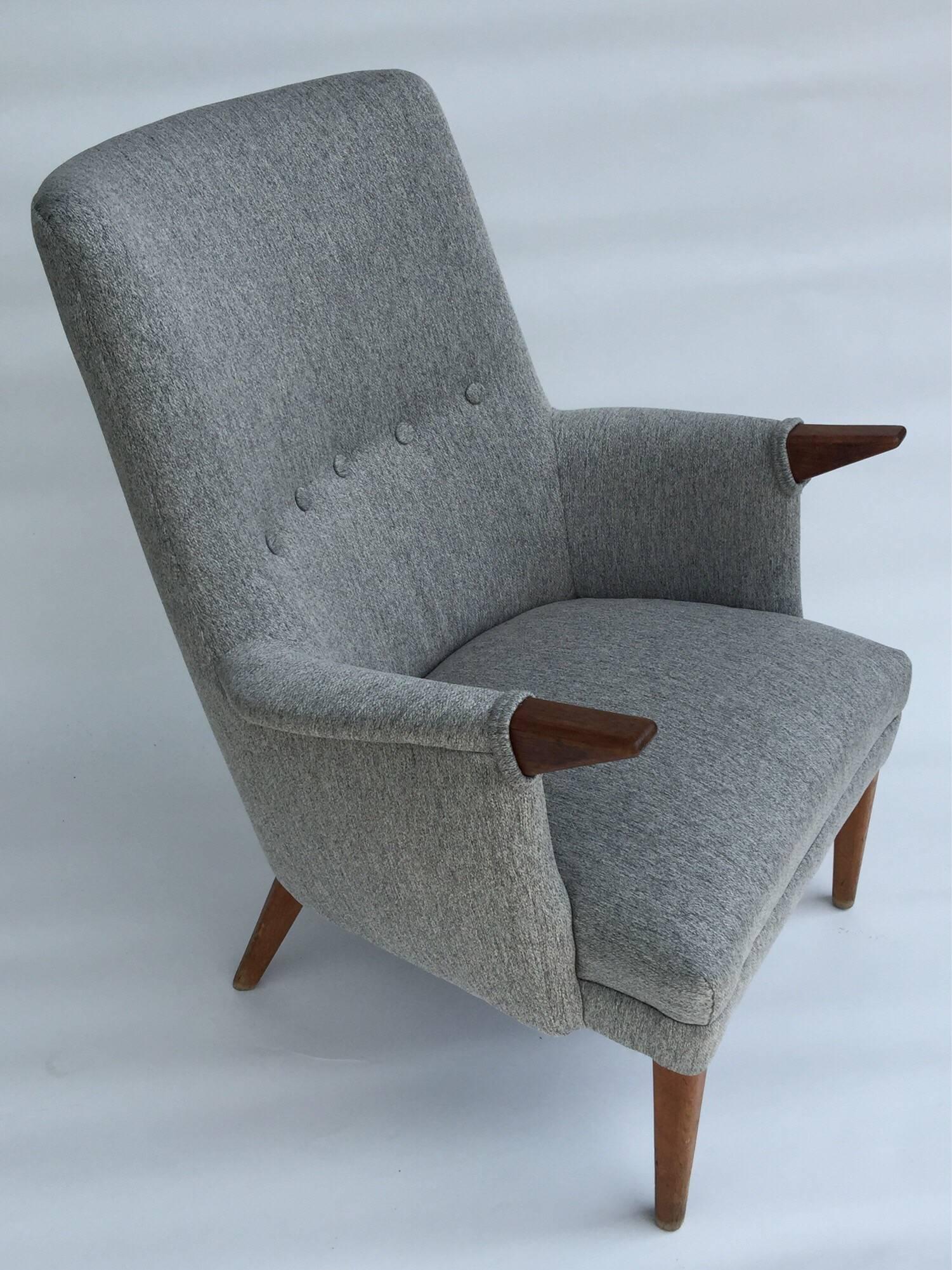 This studio built Mid-Century Modern lounge chair echoes the designs of Hans Wegner Svend Skipper and Poul Volther. Chair features multi tonal grey upholstery with button tufting and teak paws and legs with a rich patina. Elegant and modern with a