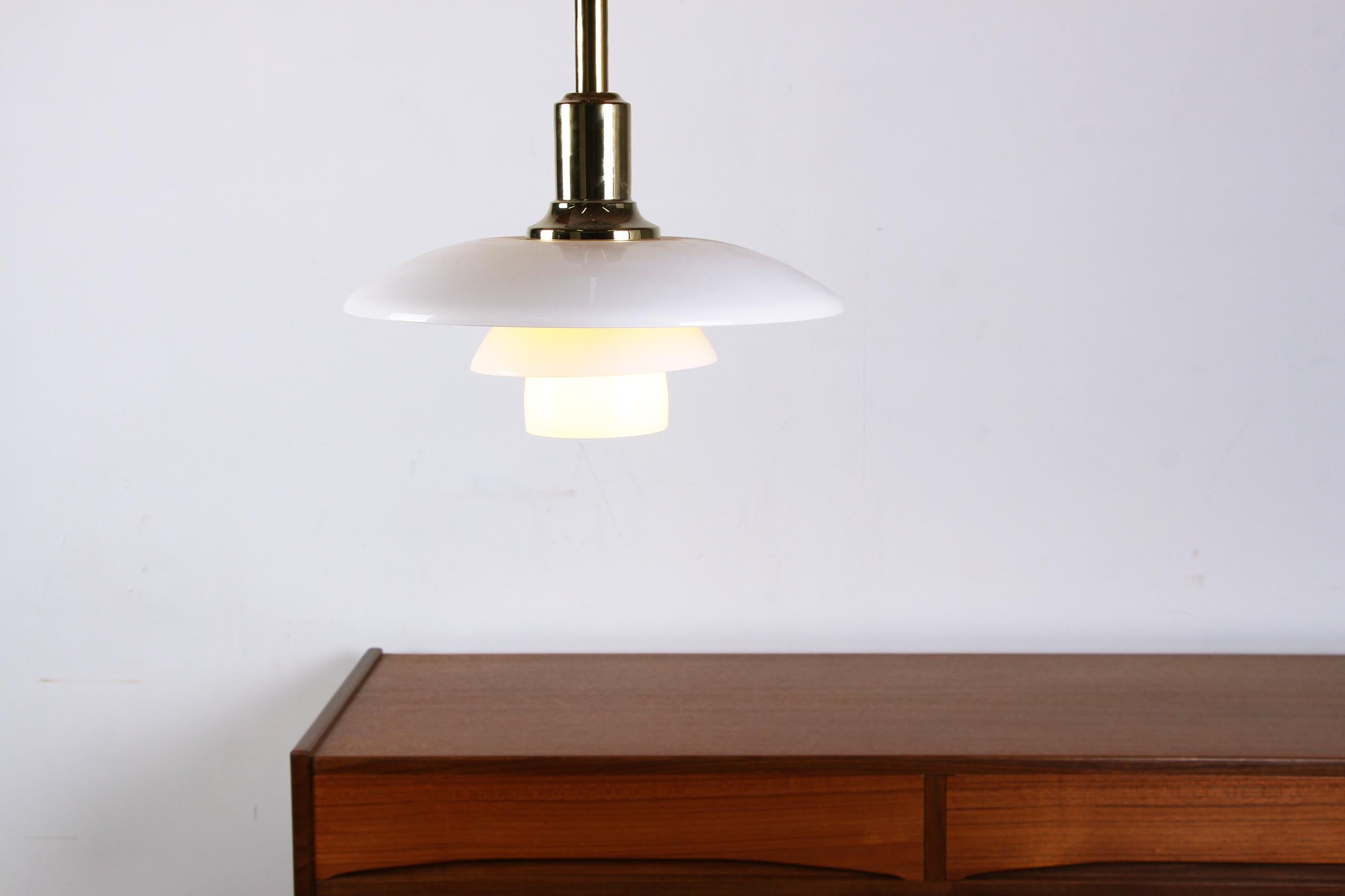 Splendida lampada a sospensione scandinava. Progettata nel 1923, la lampada a sospensione PH 3/2 offre un'illuminazione raffinata, non abbagliante ed economica. Composto da 3 cerchi di vetro sormontati da un tubo di ottone, è molto elegante e