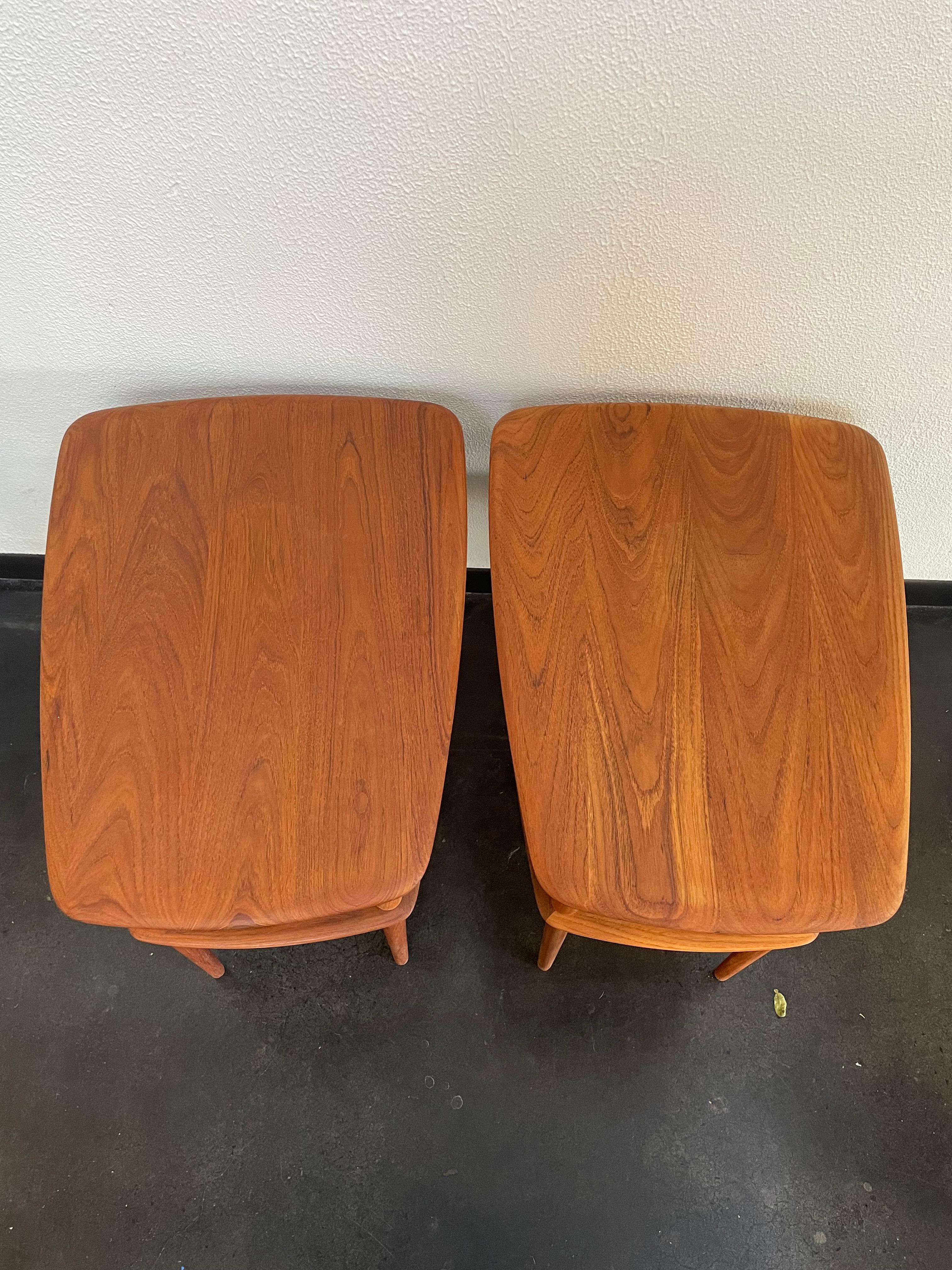 Beautifully shaped Danish Peter Hvidt France and Son teak end tables. Cane insert below table for extra shelving storage. New cane on one of them, refinished wood.