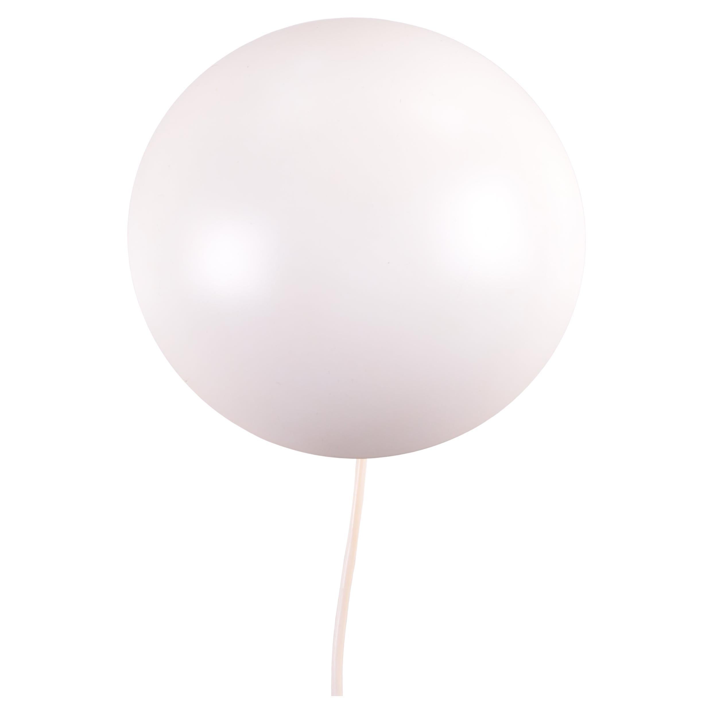 

Designed by Danish designer Poul Henningsen in 1961, the PH Hat wall lamp was originally produced in two sizes, though only the smaller model remains available today. 
Created as a bedside lamp, it features a pink inner shade that casts a soft,