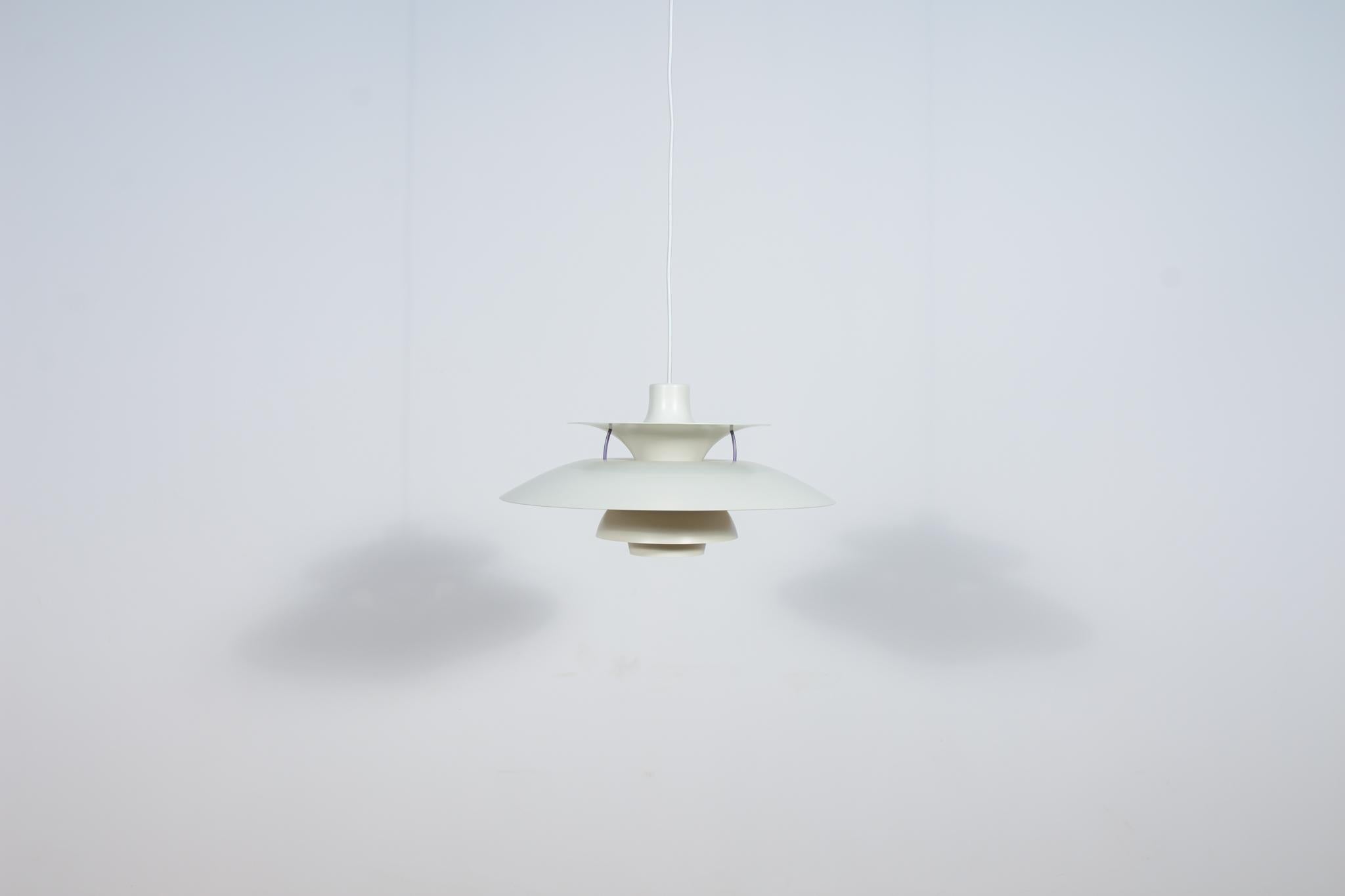 
This pendant was designed by Poul Henningsen and produced by Louis Poulsen from 1966 until it was discontinued in this color in the late 1970s to early 1980s. It is made of powder-coated aluminum and is lit both downwards and from the sides. The PH